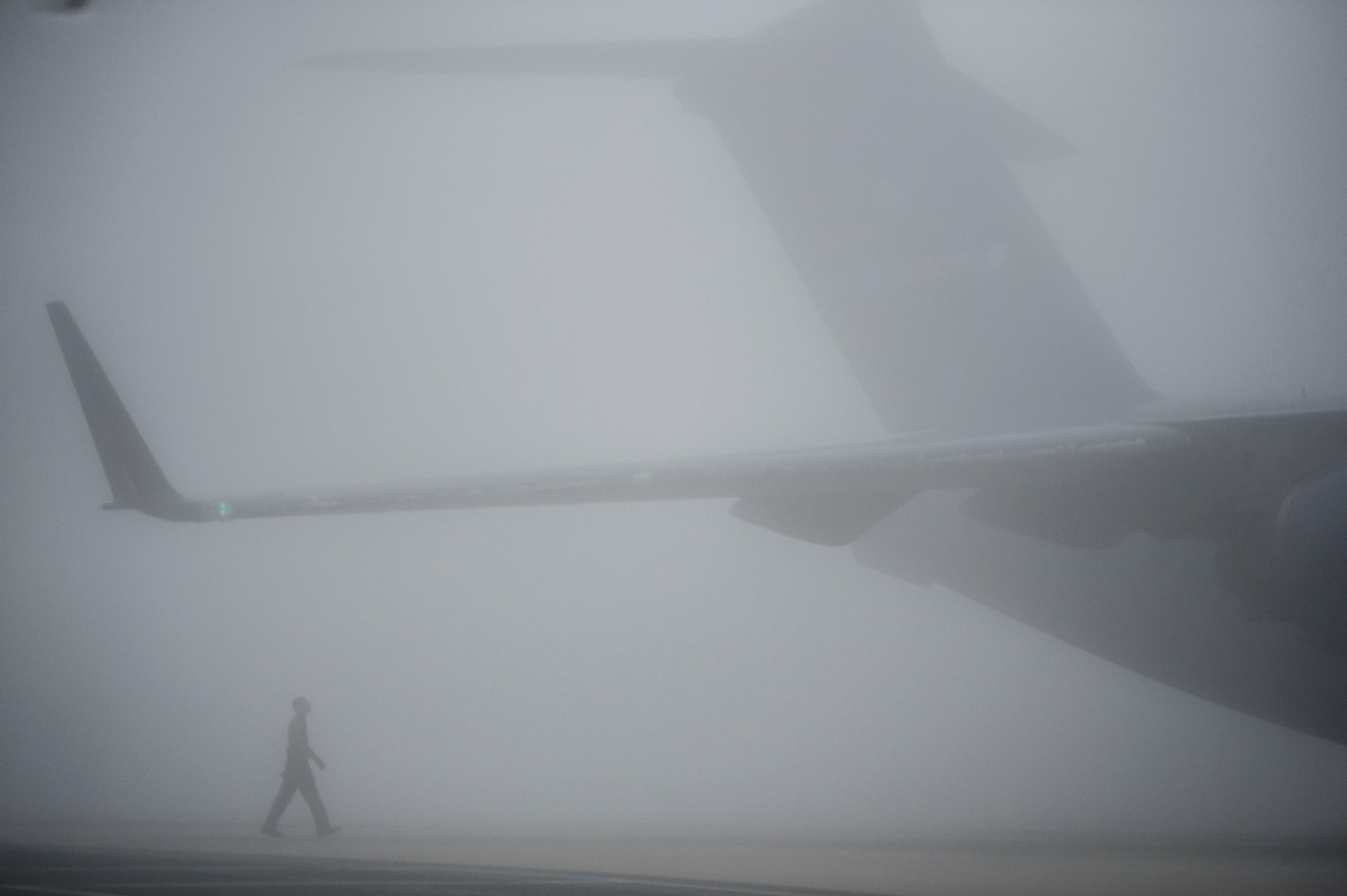 Airman 1st Class Anthony Mahon, 436th Airlift Wing, Dover Air Force Base, Del., performs a visual inspection on a Team Dover C-17 Globemaster III during thick fog prior to the aircraft’s launch, March 17, 2016. Experienced reservists from the 512th Airlift Wing frequently train active-duty Airmen in various career field tasks. (U.S. Air Force photo/ Capt. Bernie Kale)
