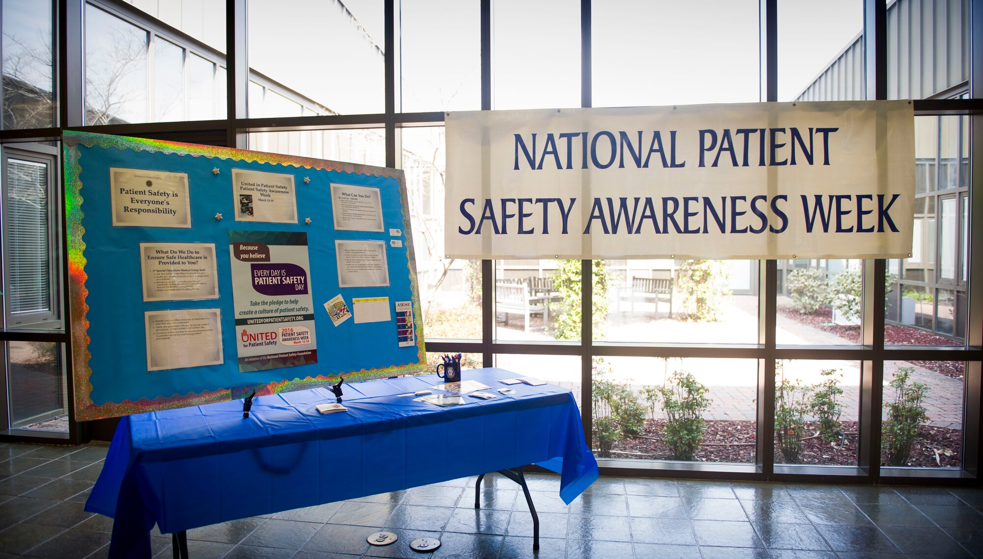 A board and banner are displayed at the 1st Special Operations Medical Group clinic on Hurlburt Field Fla., March 16, 2016. The banner advertises National Patient Safety Awareness Week and the board displays information on patient safety. (U.S. Air Force photo by Senior Airman Krystal M. Garrett) 