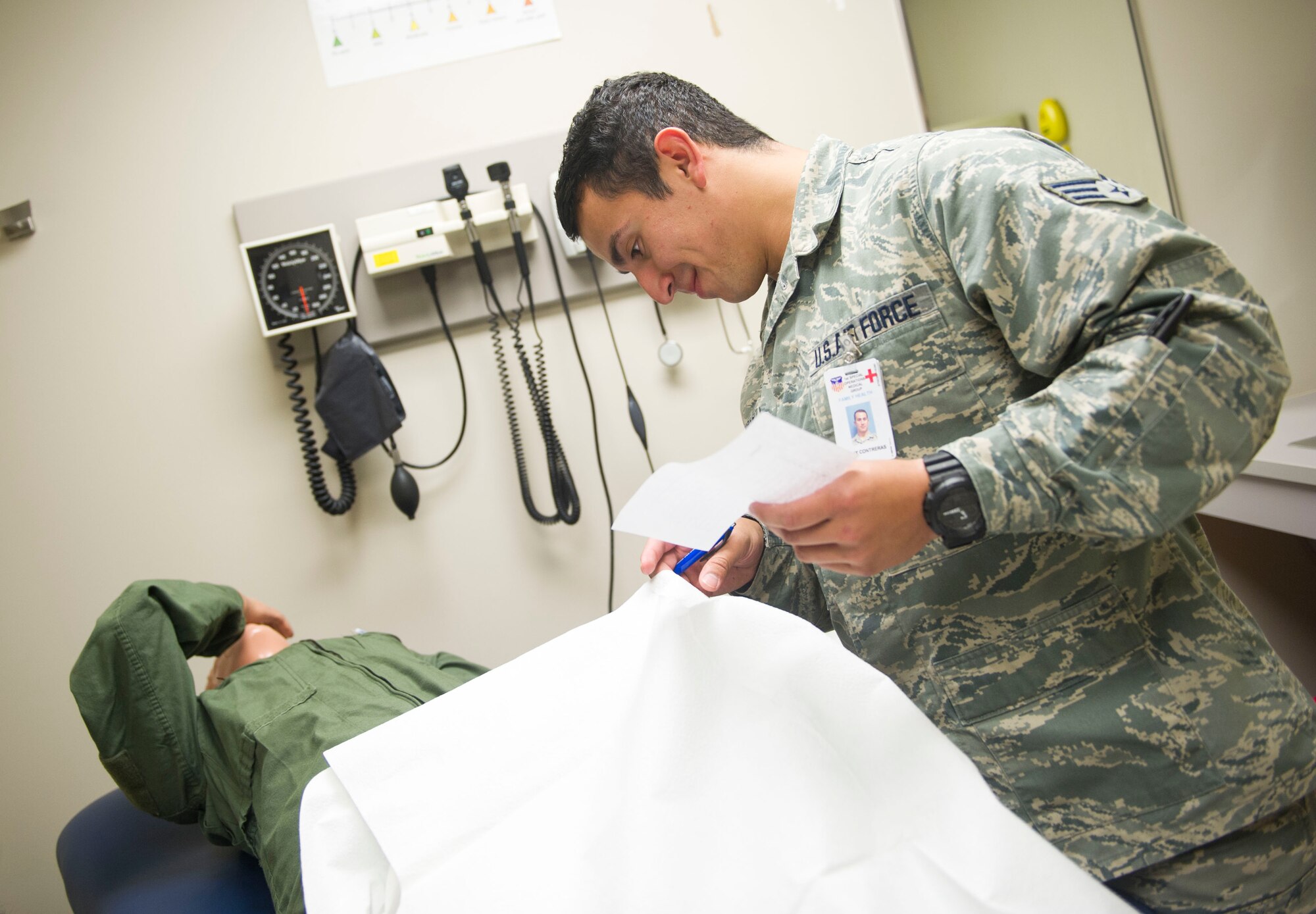 Senior Airman Felix Contreras, medical technician with the 1st Special Operations Medial Group, looks for things that are out of place in a patient care room at Hurlburt Field, Fla., March 16, 2016. Airmen with the 1st SOMDG participated in the ‘Room of Blunders’ training exercise to enhance their awareness safety hazards in a patient care room. (U.S. Air Force photo by Senior Airman Krystal M. Garrett)