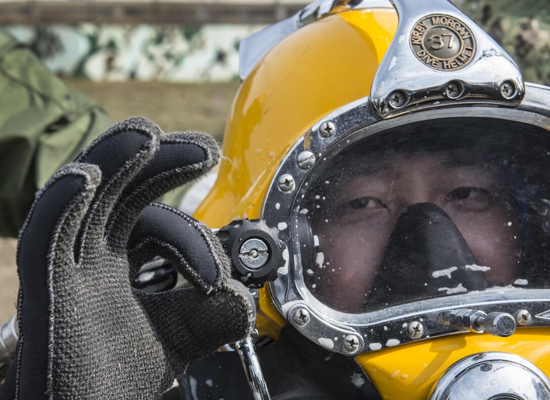 South Korean Chief Petty Officer Dong Soon-jung gestures to a dive supervisor before entering the water to work on a simulated expeditionary wharf during Exercise Foal Eagle 2016 at Chinhae, South Korea, March 10, 2016. Navy photo by Petty Officer 1st Class Charles E. White