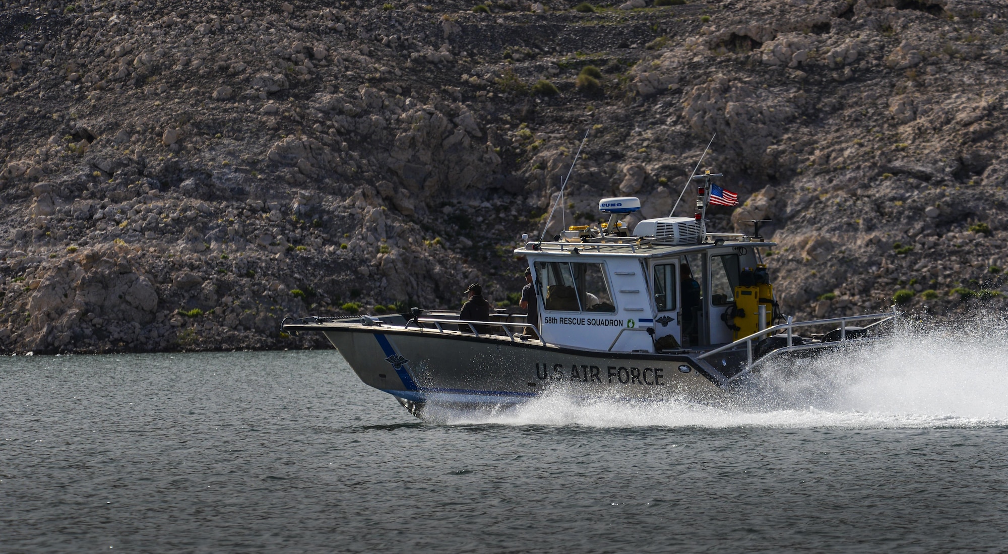 A Nellis Air Force Base, Nevada, 58th Rescue Squadron boat speeds across the water during a training exercise at Lake Mead, March 15, 2016. The boat picked up Pararescuemen after preforming static line jumps out of a C-130. Pararescue teams assault, secure, and dominate the rescue objective area utilizing any available DOD or Allied, air, land, or sea asset. (U.S. Air Force photo by Airman 1st Class Kevin Tanenbaum)
