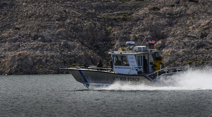 A Nellis Air Force Base, Nevada, 58th Rescue Squadron boat speeds across the water during a training exercise at Lake Mead, March 15, 2016. The boat picked up Pararescuemen after preforming static line jumps out of a C-130. Pararescue teams assault, secure, and dominate the rescue objective area utilizing any available DOD or Allied, air, land, or sea asset. (U.S. Air Force photo by Airman 1st Class Kevin Tanenbaum)