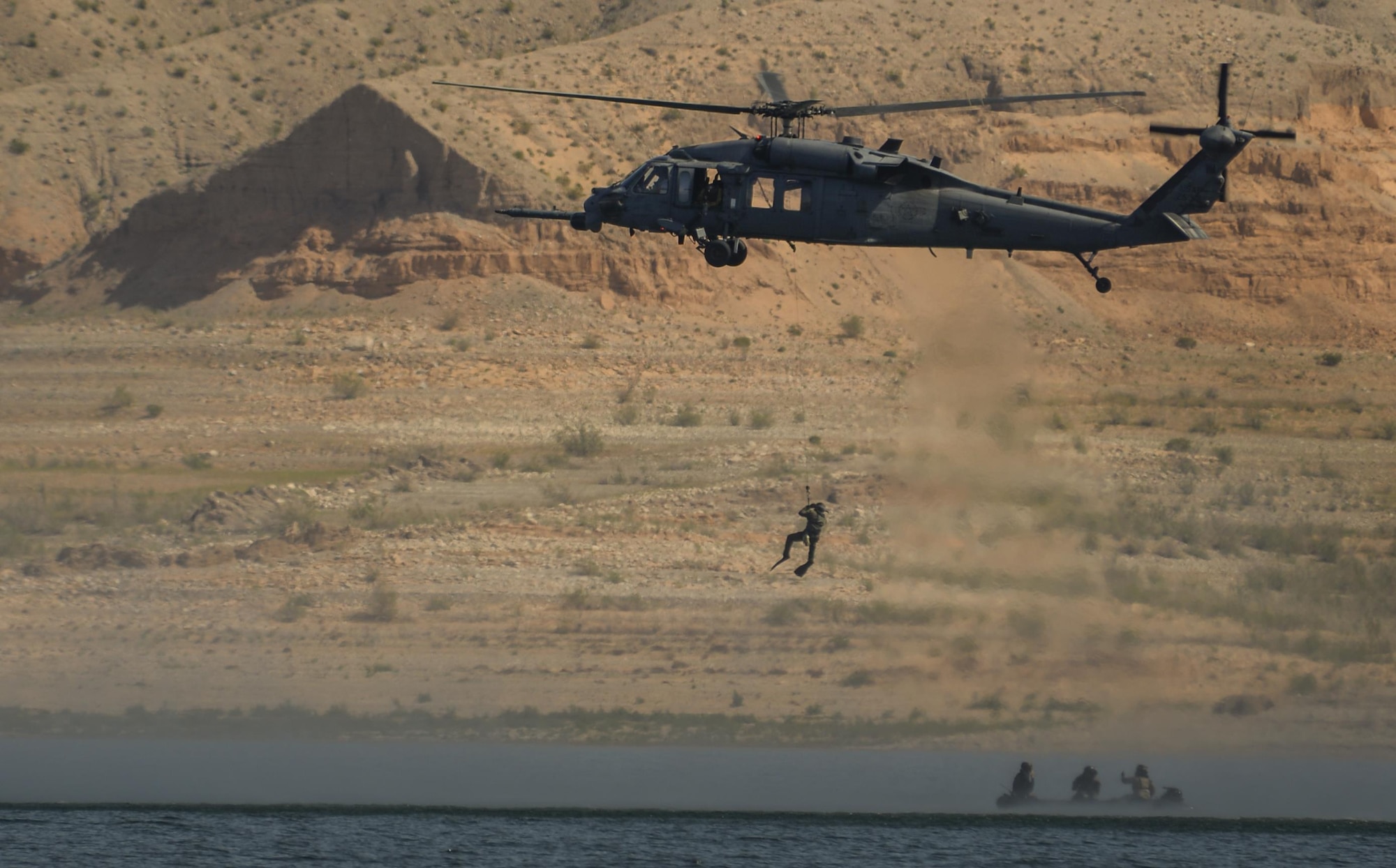 An HH-60G Pave Hawk, assigned to the 58th Rescue Squadron from Nellis Air Force Base, Nevada, preforms water operations training at Lake Mead, March 15, 2016. Pararescuemen receive comprehensive initial training and spend their careers continuously developing their proficiency in all phases of their career-field’s capabilities. (U.S. Air Force photo by Airman 1st Class Kevin Tanenbaum)