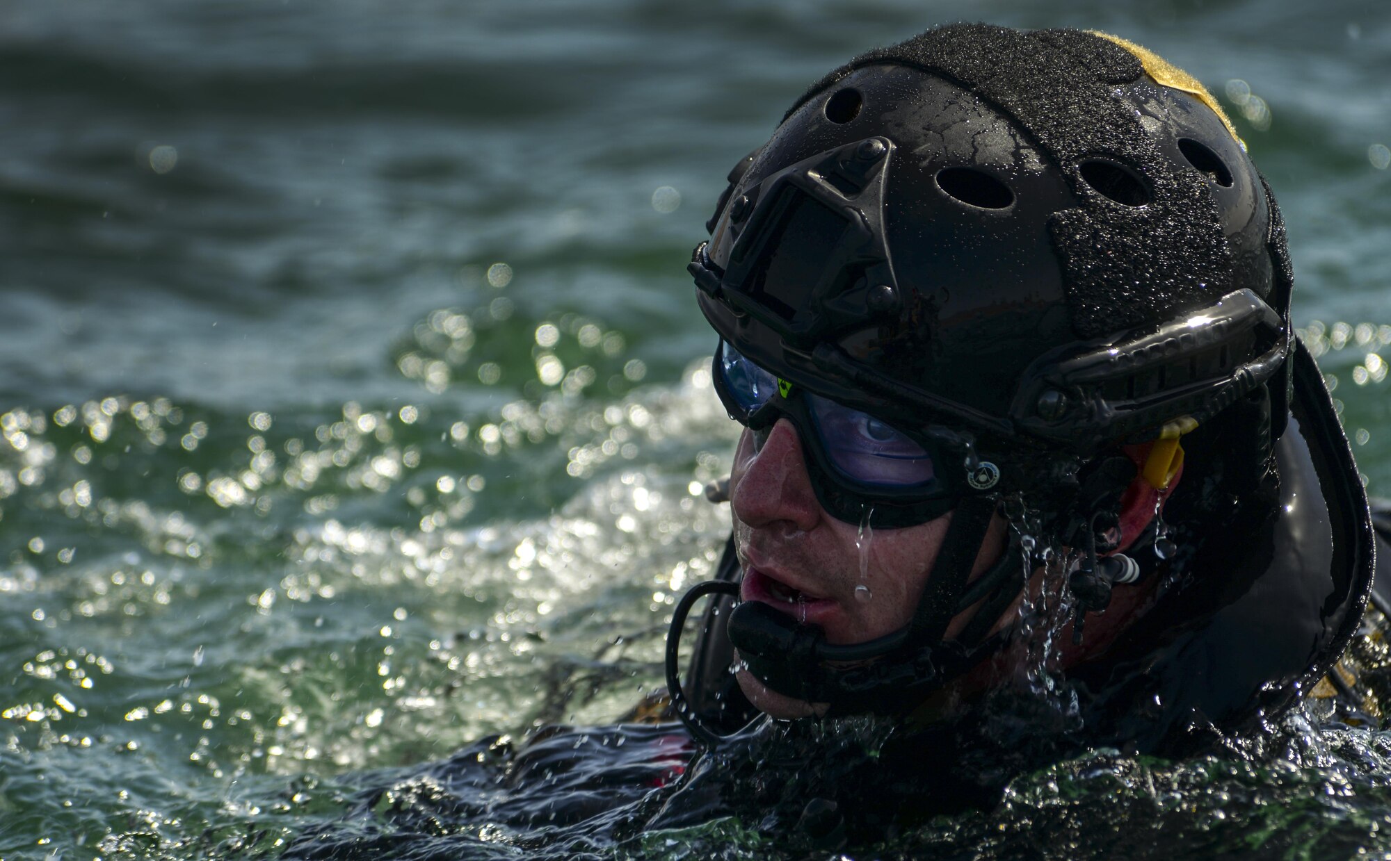 Capt. Daniel L Catino assigned to the 58th Rescue Squadron at Nellis Air Force Base, Nevada, waits to enter a rescue boat after preforming a static line jump out of a C-130 over Lake Mead, March 15, 2016. The mission of the Pararescue is to rescue, recover, and return American or Allied forces in times of danger or extreme duress. (U.S. Air Force photo by Airman 1st Class Kevin Tanenbaum)