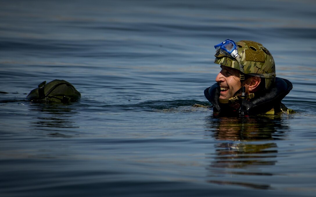 A Pararescuemen, assigned to the 58th Rescue Squadron at Nellis Air Force Base, Nevada waits to be picked up by a rescue boat after preforming a static line jump out of a C-130 over Lake Mead, March 15, 2016. Pararescue is the only United States Department of Defense elite combat force specifically organized, trained, equipped, and postured to conduct full spectrum personnel recovery to include both conventional and unconventional combat rescue operations. (U.S. Air Force photo by Airman 1st Class Kevin Tanenbaum)