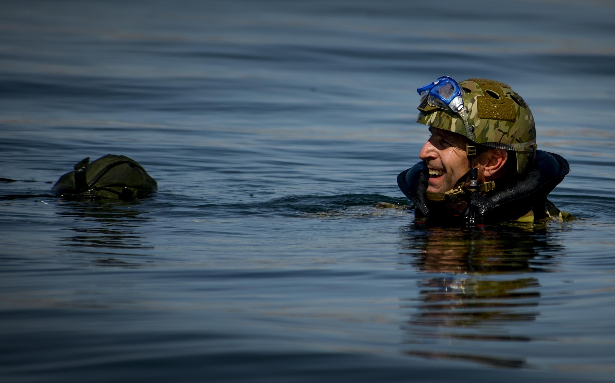 A Pararescuemen, assigned to the 58th Rescue Squadron at Nellis Air Force Base, Nevada waits to be picked up by a rescue boat after preforming a static line jump out of a C-130 over Lake Mead, March 15, 2016. Pararescue is the only United States Department of Defense elite combat force specifically organized, trained, equipped, and postured to conduct full spectrum personnel recovery to include both conventional and unconventional combat rescue operations. (U.S. Air Force photo by Airman 1st Class Kevin Tanenbaum)