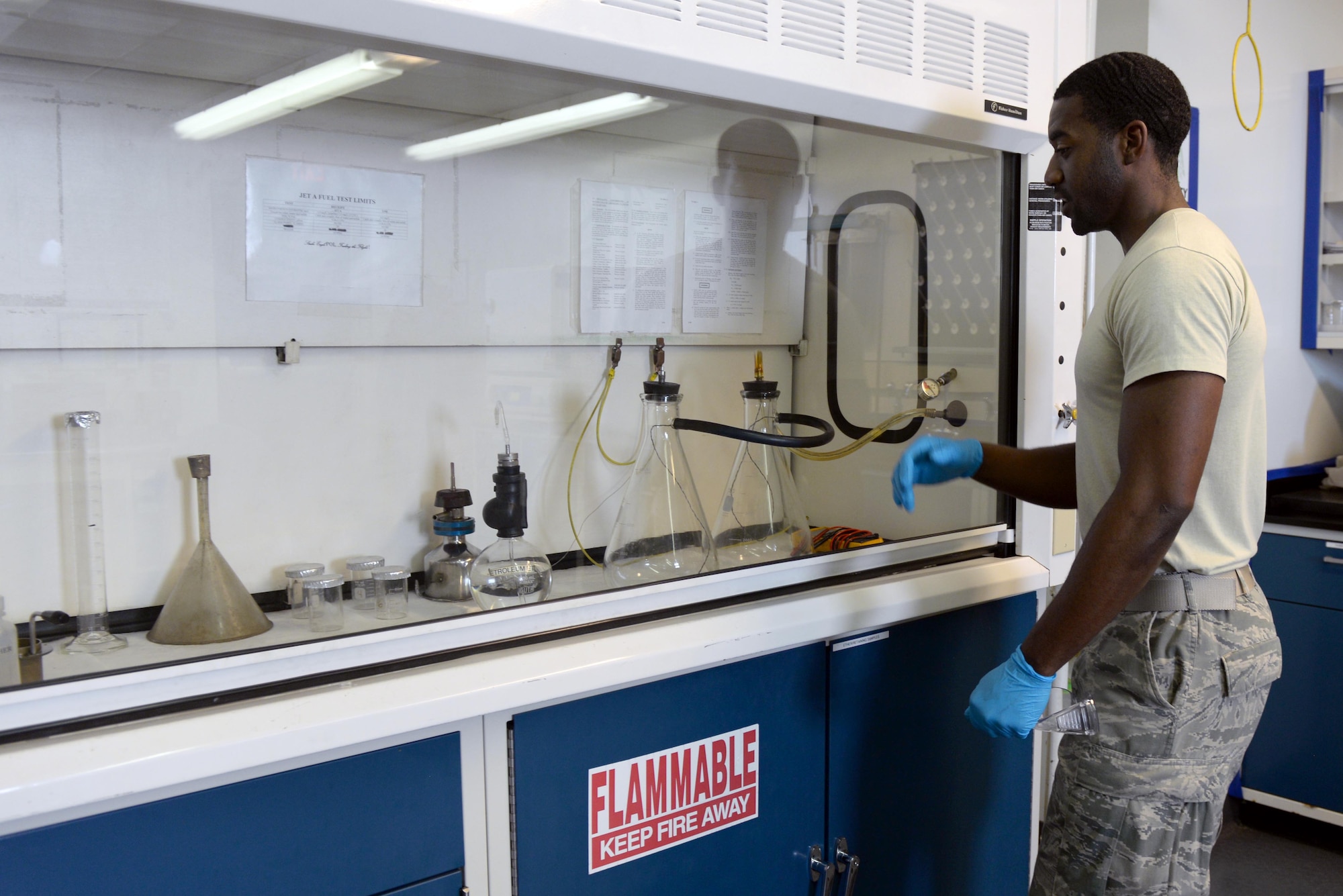Senior Airman Terrence Baker, 4th Logistics Readiness Squadron petroleum, oil, and lubricants fuels lab technician, prepares lab instruments to test fuel samples, March 16, 2016, at Seymour Johnson Air Force Base, North Carolina. Samples are tested daily for water and other chemicals that might pollute the fuel. (U.S. Air Force photo/Airman 1st Class Ashley Williamson)