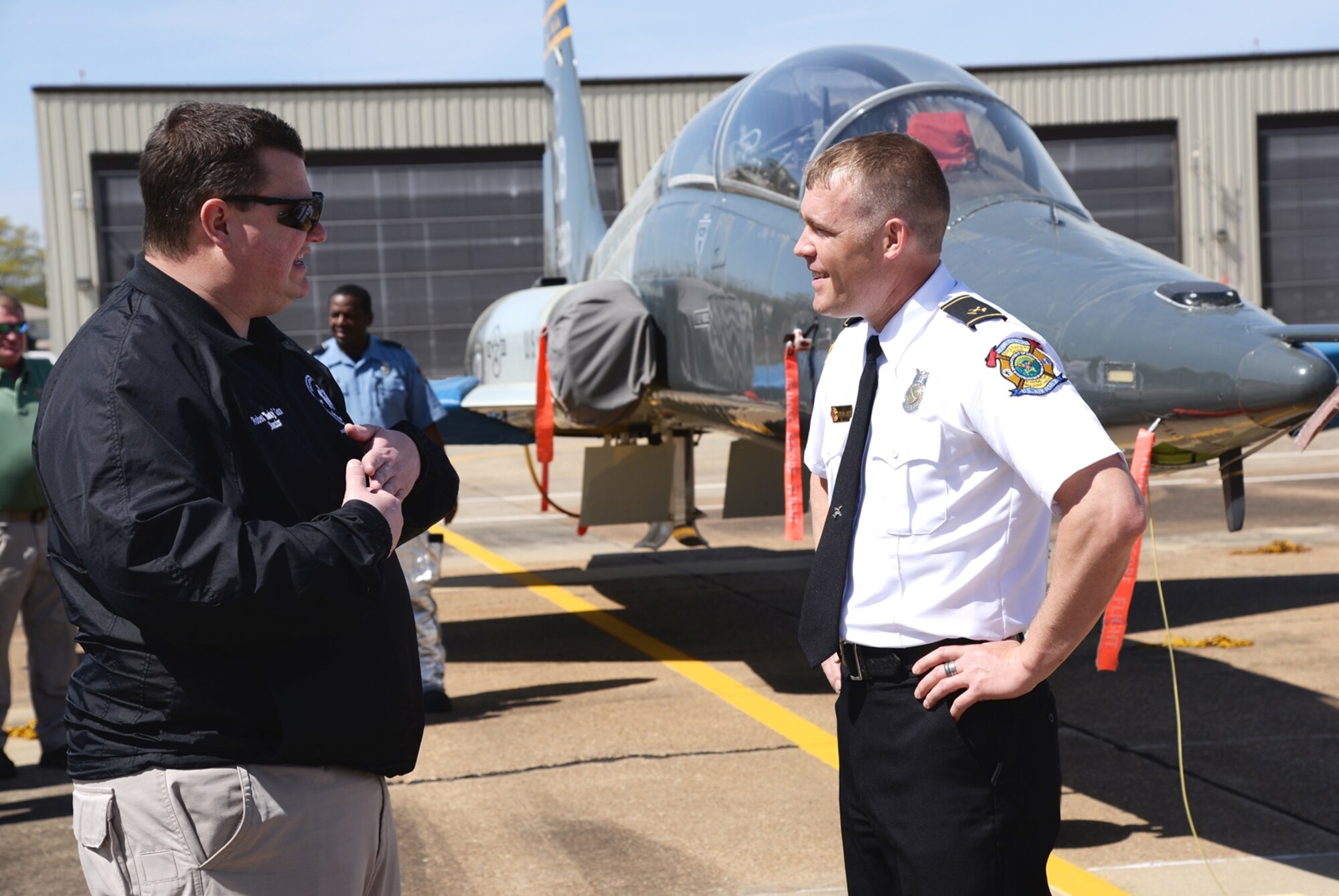 Robert “Bunky” Goza, Monroe County Emergency Operations Director, speaks with William O’Meara, 14th Civil Engineer Squadron Fire Inspector, during the Regional Fire Chief Meeting March 17 at Columbus Air Force Base, Mississippi. Attendees came from several locations to meet. While they were on base they were able to view the fire station, various static displays of aircraft and emergency vehicles, and they received mission brief before going to a luncheon. (U.S. Air Force photo/Airman 1st Class John Day)