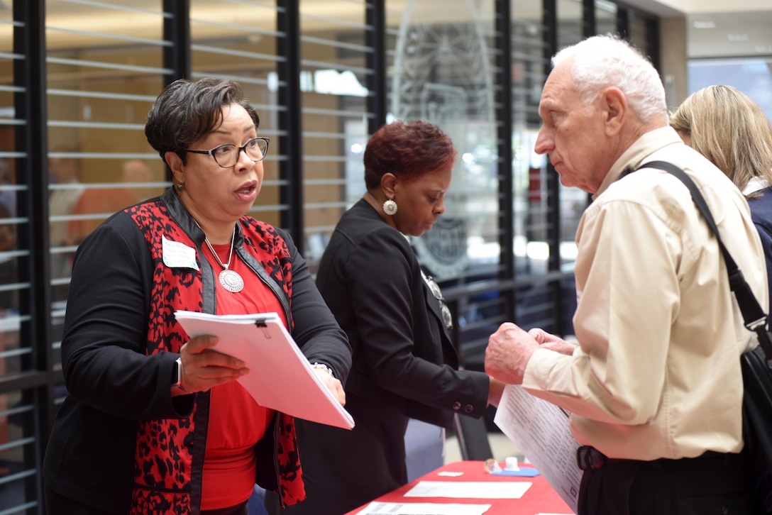 Karen Brady (Left), U.S. Army Corps of Engineers Memphis District Small Business Program manager, and Estella Blackman, also from the Memphis District, assist Jim Speakman of Powers Hill Designs LLC., during the 5th Annual Small Business Forum at Tennessee State University in Nashville, Tenn., March 17, 2016.