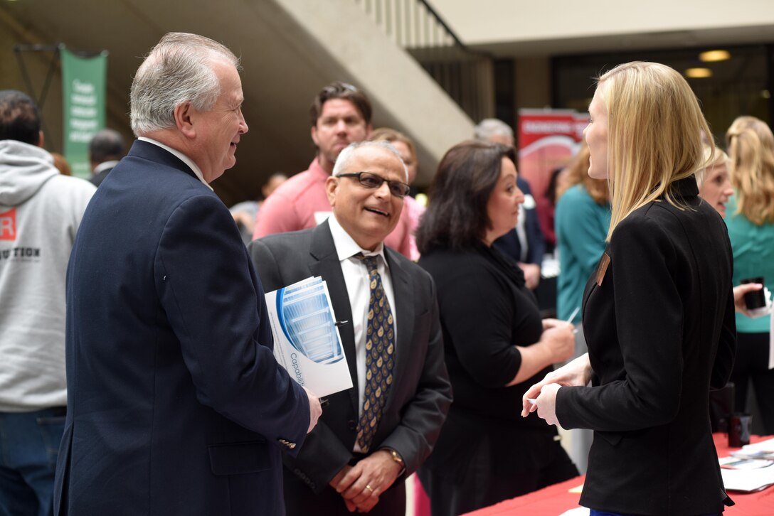 Crystal May, U.S. Army Corps of Engineers Louisville District Small Business Office chief, assists several attendees with their questions during the 5th Annual Small Business Forum at Tennessee State University in Nashville, Tenn., March 17, 2016. 