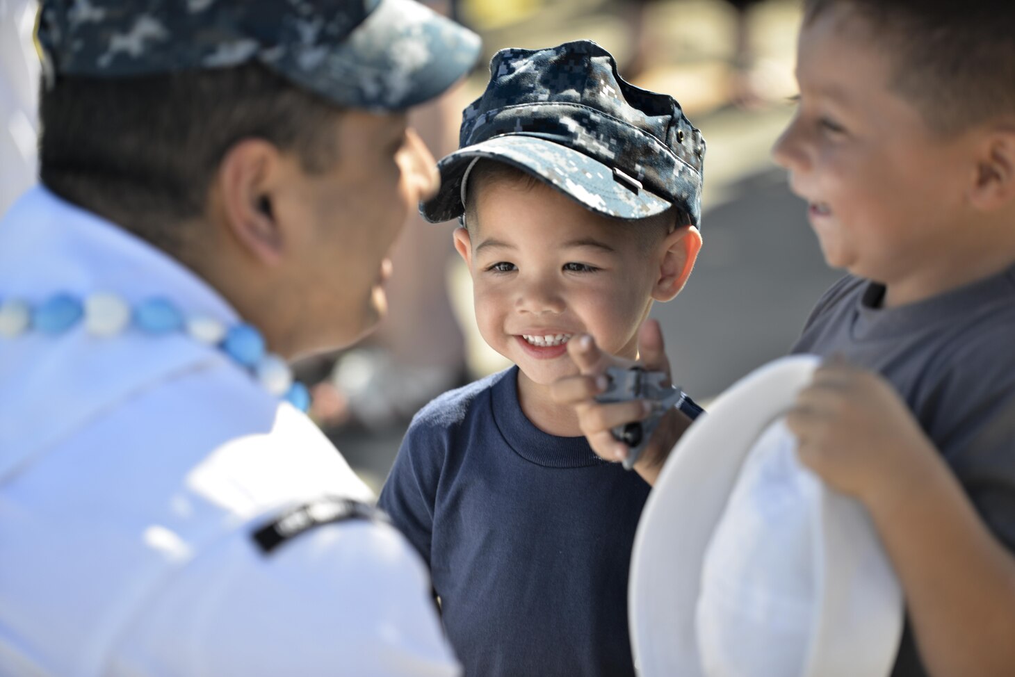 PEARL HARBOR (March 17, 2016) Culinary Specialist 2nd Class Claro Marasigan, of Portland, Ore., greets his sons Cameron, right, and CJ, middle, following the return of the Virginia-class fast-attack submarine USS North Carolina (SSN 777) to Pearl Harbor after completing a successful six-month Western Pacific deployment. (U.S. Navy photo by Mass Communication Specialist 2nd Class Michael H. Lee/Released)