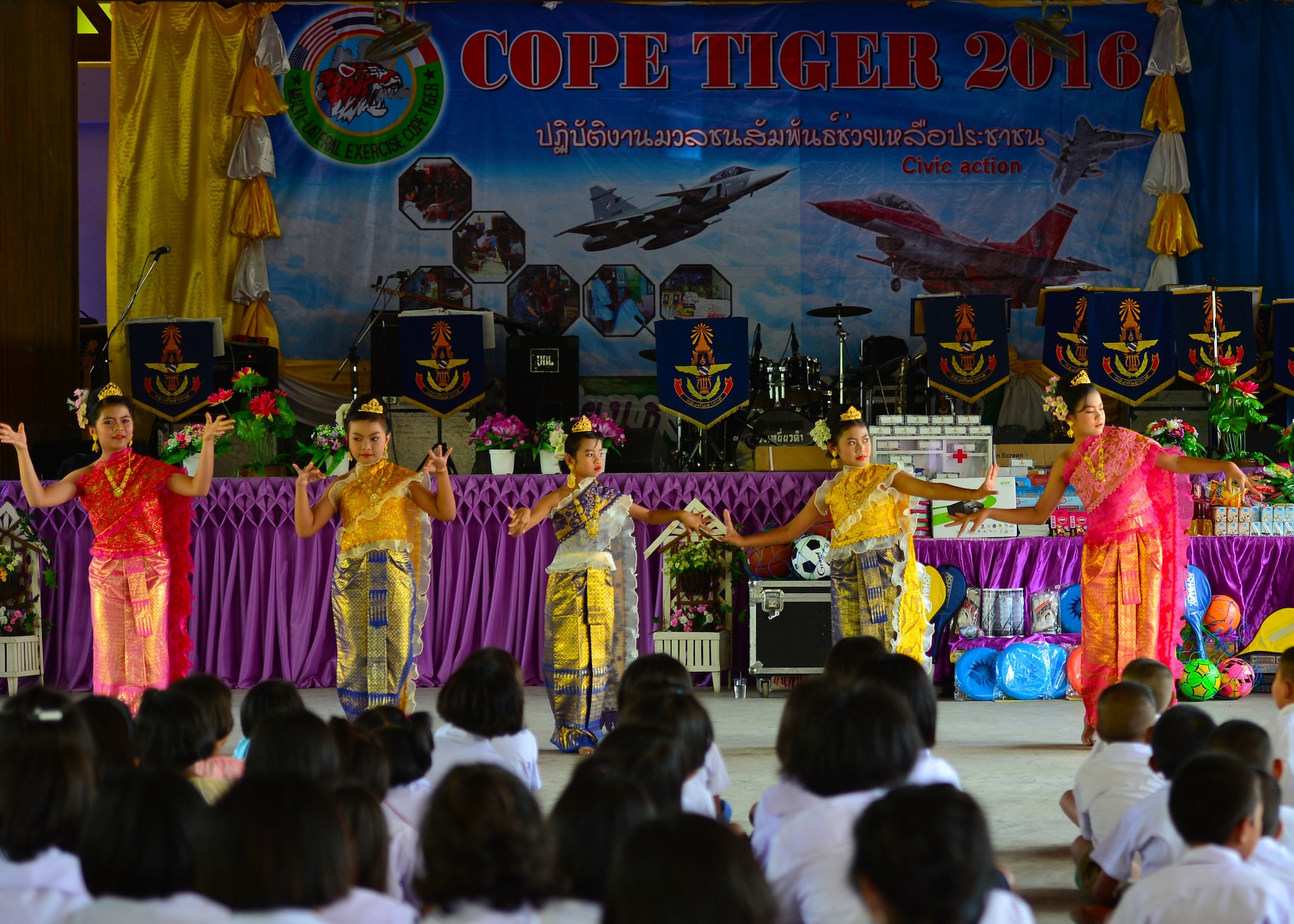 Students from Thong Chai Wittaya Primary School perform as a part of the combined civic action engagement during Exercise Cope Tiger 16, Thong Chai Wittaya Primary School, Korat, Thailand, March 15, 2016. The combined civic action engagement provides an outlet for the countries participating in Cope Tiger to give back to the community surrounding Korat Royal Thai Air Force Base. Exercise Cope Tiger is multilateral field training exercise and includes more than 1,200 personnel from the United States, Thailand and Singapore. The purpose of this exercise is to improve readiness and interoperability between three countries and continue the growth of strong relationships within the Asia-Pacific Region. (U.S. Air Force Photo by Tech Sgt. Aaron Oelrich/Released)Students from Thong Chai Wittaya Primary School perform as a part of the combined civic action engagement during Exercise Cope Tiger 16, Thong Chai Wittaya Primary School, Korat, Thailand, March 15, 2016. The combined civic action engagement provides an outlet for the countries participating in Cope Tiger to give back to the community surrounding Korat Royal Thai Air Force Base. Exercise Cope Tiger is multilateral field training exercise and includes more than 1,200 personnel from the United States, Thailand and Singapore. The purpose of this exercise is to improve readiness and interoperability between three countries and continue the growth of strong relationships within the Asia-Pacific Region. (U.S. Air Force Photo by Tech Sgt. Aaron Oelrich/Released)