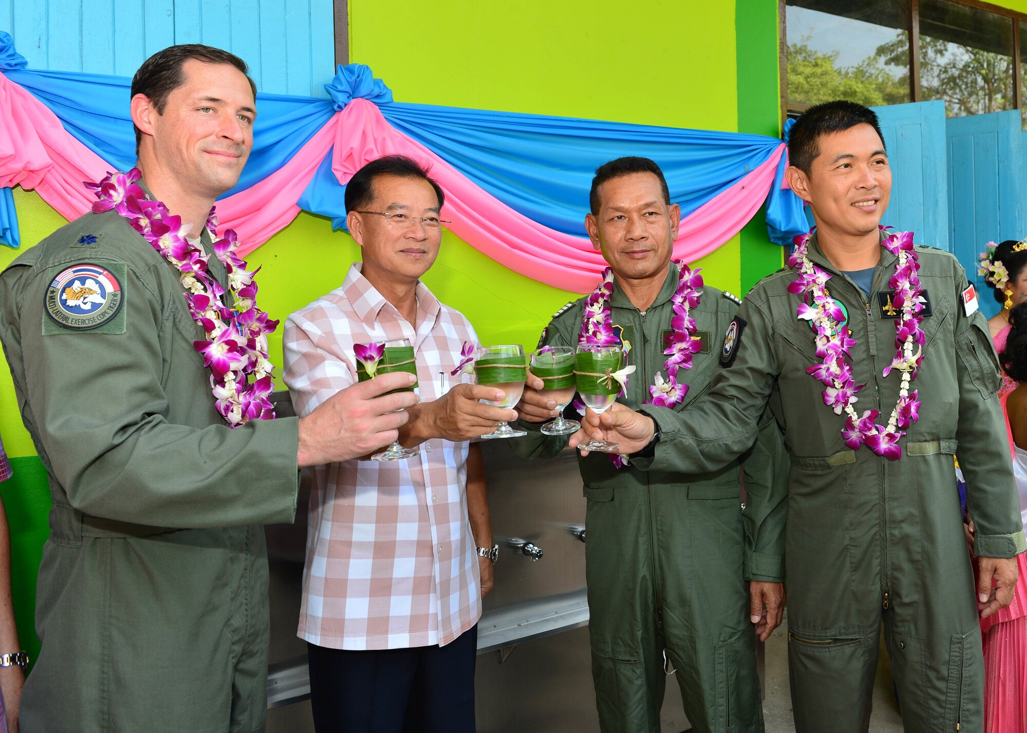 Col. Jack Arthaud, exercise director for the U.S. Air Force, Mr. Sommai Wichianchan, Deputy Governor of Korat, Thailand, Group Captain Manoon Rukitna, exercise director for the Royal Thailand Air Force, and Col. Sim Pengshin, exercise director from the Republic of Singapore Air Force, Take a ceremonial sip of water from the new water filtration system donated by military members and civilians participating in this year’s Exercise Cope Tiger during a combined civic action engagement  at Thong Chai Wittaya Primary School, Korat, Thailand, March 15, 2016. The combined civic action engagement provides an outlet for the countries participating in Cope Tiger to give back to the community surrounding Korat Royal Thai Air Force Base. Exercise Cope Tiger is multilateral field training exercise and includes more than 1,200 personnel from the United States, Thailand and Singapore. The purpose of this exercise is to improve readiness and interoperability between three countries and continue the growth of strong relationships within the Asia-Pacific Region. (U.S. Air Force Photo by Tech Sgt. Aaron Oelrich/Released)