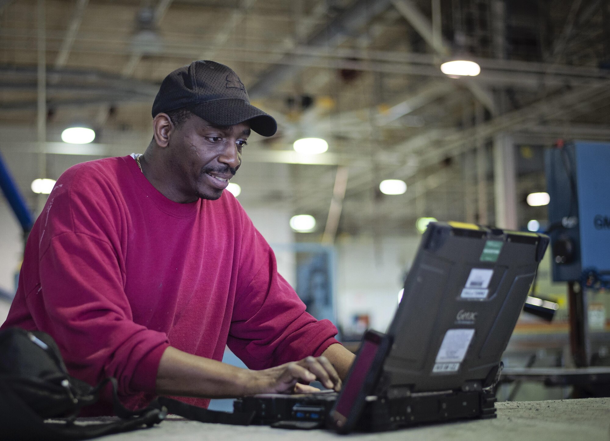 Master Sgt. Antoine Robinson, 512th Maintenance Squadron, reads part of a letter and recalls the feeling of accomplishment on Dover Air Force Base, Del., March 18, 2016, when talking about the day he received the official email notifying him that he had fulfilled all requirements to receive his Community College of the Air Force degree. Robinson is 1 of 61 Airmen graduating in the 512th Airlift Wing’s spring class. (U.S. Air Force photo/Capt. Bernie Kale)