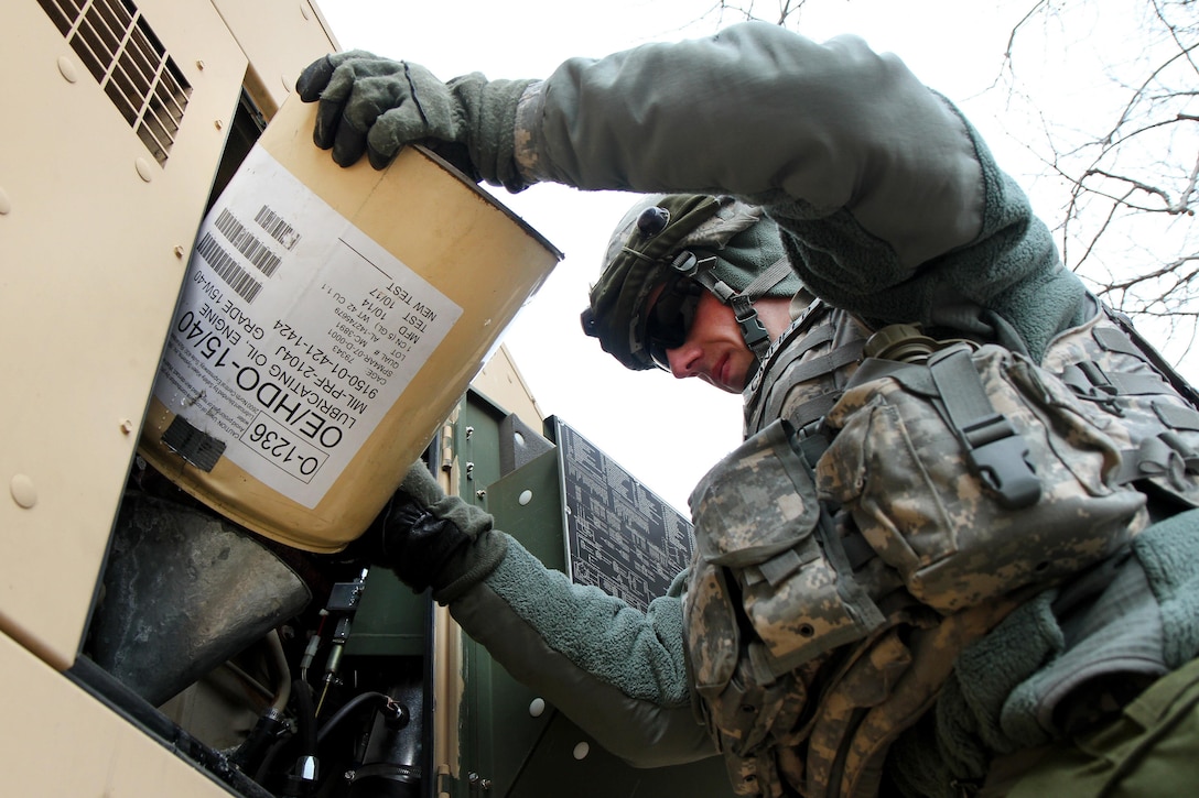 Army Spc. Ryan Canfield adds oil to a generator used to power a reverse osmosis water purification unit at the Brindle Lake training area on Joint Base McGuire-Dix-Lakehurst, N.J., March 6, 2016. Canfield, assigned to the 301st Quartermaster Company, operated the water purification unit to provide potable water to soldiers training during Combat Support Training Exercise 78-16-01. Army photo by Spc. Michael McDevitt