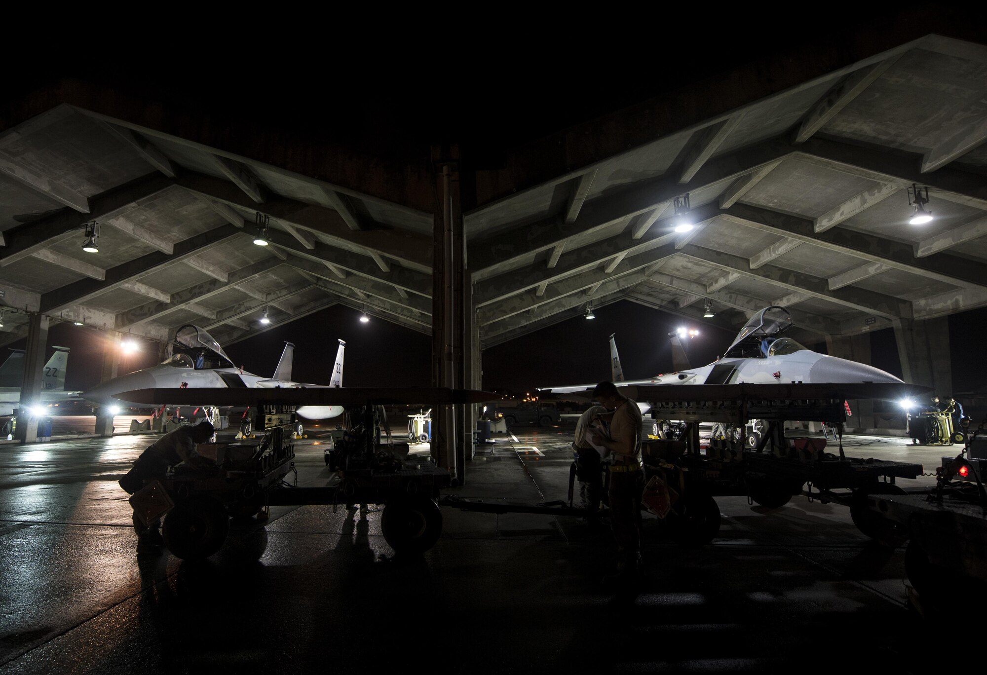 Airmen with the 44th Aircraft Maintenance Unit scramble to prepare F-15 Eagles during a no-notice exercise March 18, 2016, at Kadena Air Base, Japan. 44th AMXS Airmen practice for situations like these through regular training and weapons load crew competitions. (U.S. Air Force photo by Senior Airman Omari Bernard/Released)