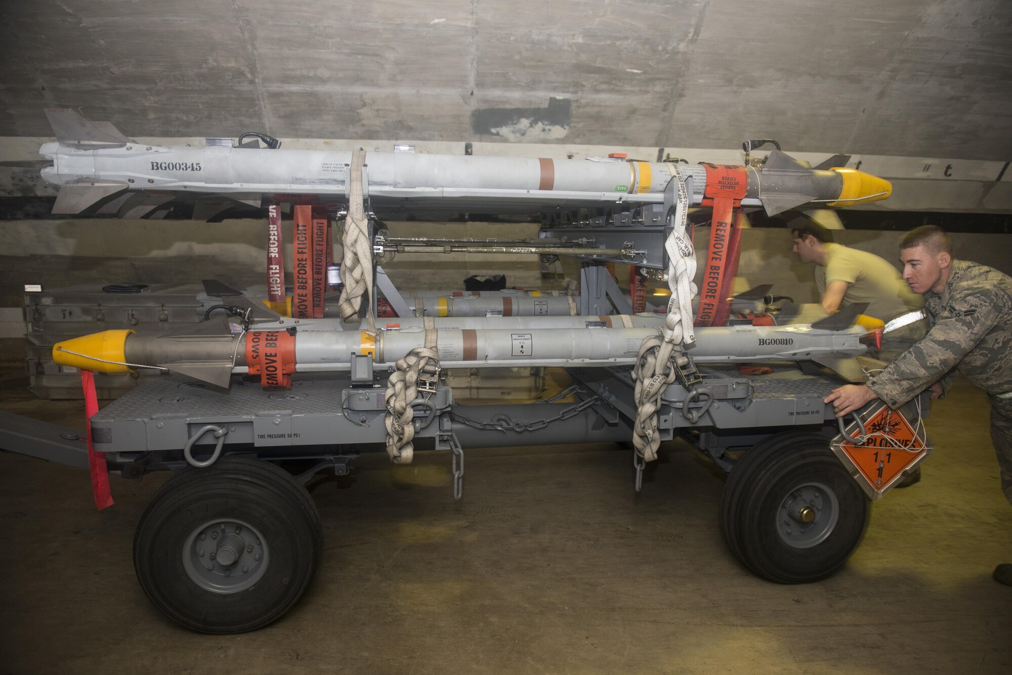 Airmen with the 18th Munitions Squadron move AIM-9X Sidewinder missiles to the flight line during a no-notice exercise March 17, 2016, at Kadena Air Base, Japan. 18th MUNS Airmen are prepared night or day to transport munitions quickly and safely. (U.S. Air Forces photo by Senior Airman Omari Bernard/Released)