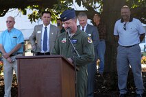 Col. Mark Slocum, 4th Fighter Wing commander, speaks to the community about an F-86 Sabre static display and the Airmen who renovated it, March 17, 2016, in downtown Goldsboro, North Carolina. Airmen from the 4th Equipment Maintenance Squadron worked over a year and spent 644 hours restoring the aircraft. (U.S. Air Force photo/Airman 1st Class Ashley Williamson)