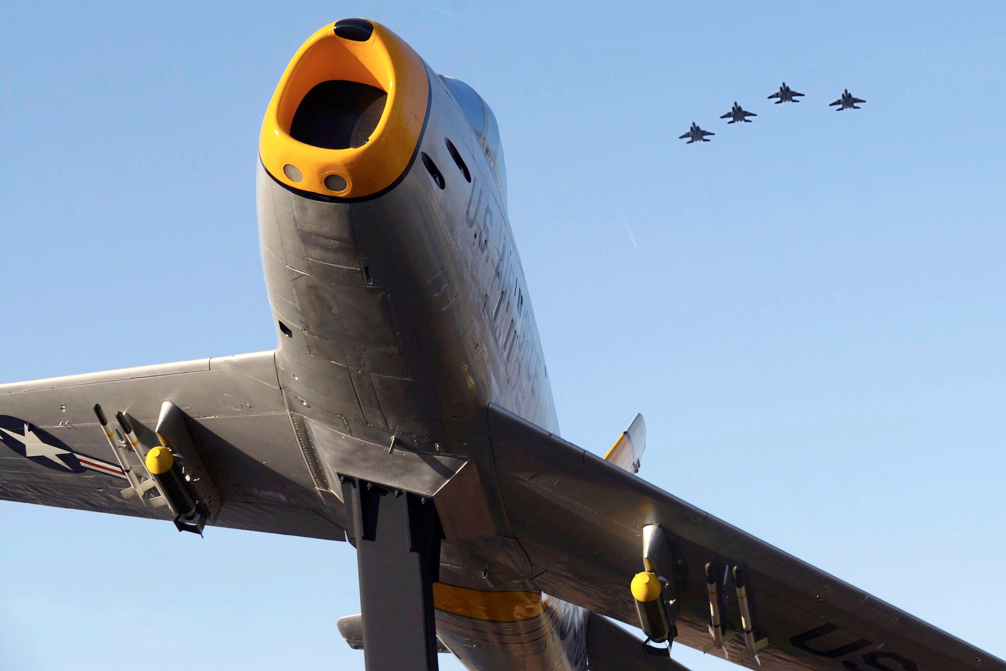 A 4-ship of F-15E Strike Eagles assigned to the 334th Fighter Squadron at Seymour Johnson Air Force Base, North Carolina, perform a flyby during an F-86 Sabre re-dedication ceremony March 17, 2016, in downtown Goldsboro, North Carolina. The F-86 Sabre was fully restored by Team Seymour Airmen who performed structural and corrosion repair to the aircraft. (U.S. Air Force photo/Airman 1st Class Ashley Williamson) 