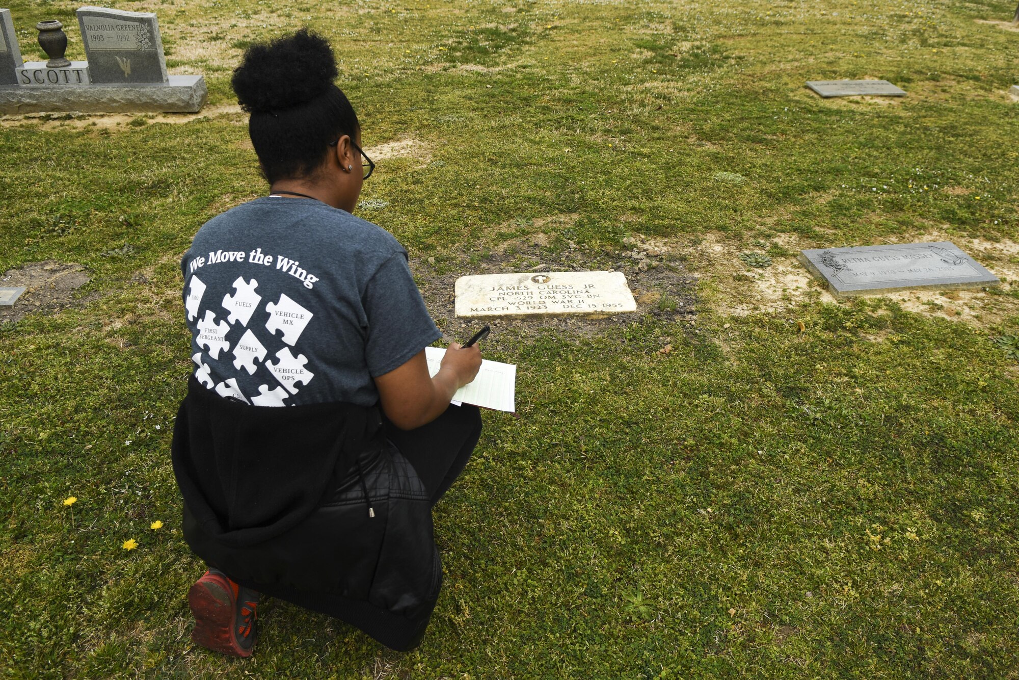 Senior Airman Abony Owens, 916th Logistic Readiness Squadron supply technician, writes down the name and location of a veteran, March 12, 2016, in Goldsboro, North Carolina. Students of Airman Leadership School class 16-C volunteered to document and map the locations of veterans buried in Elmwood Cemetery. (U.S. Air Force photo/Airman Shawna L. Keyes)