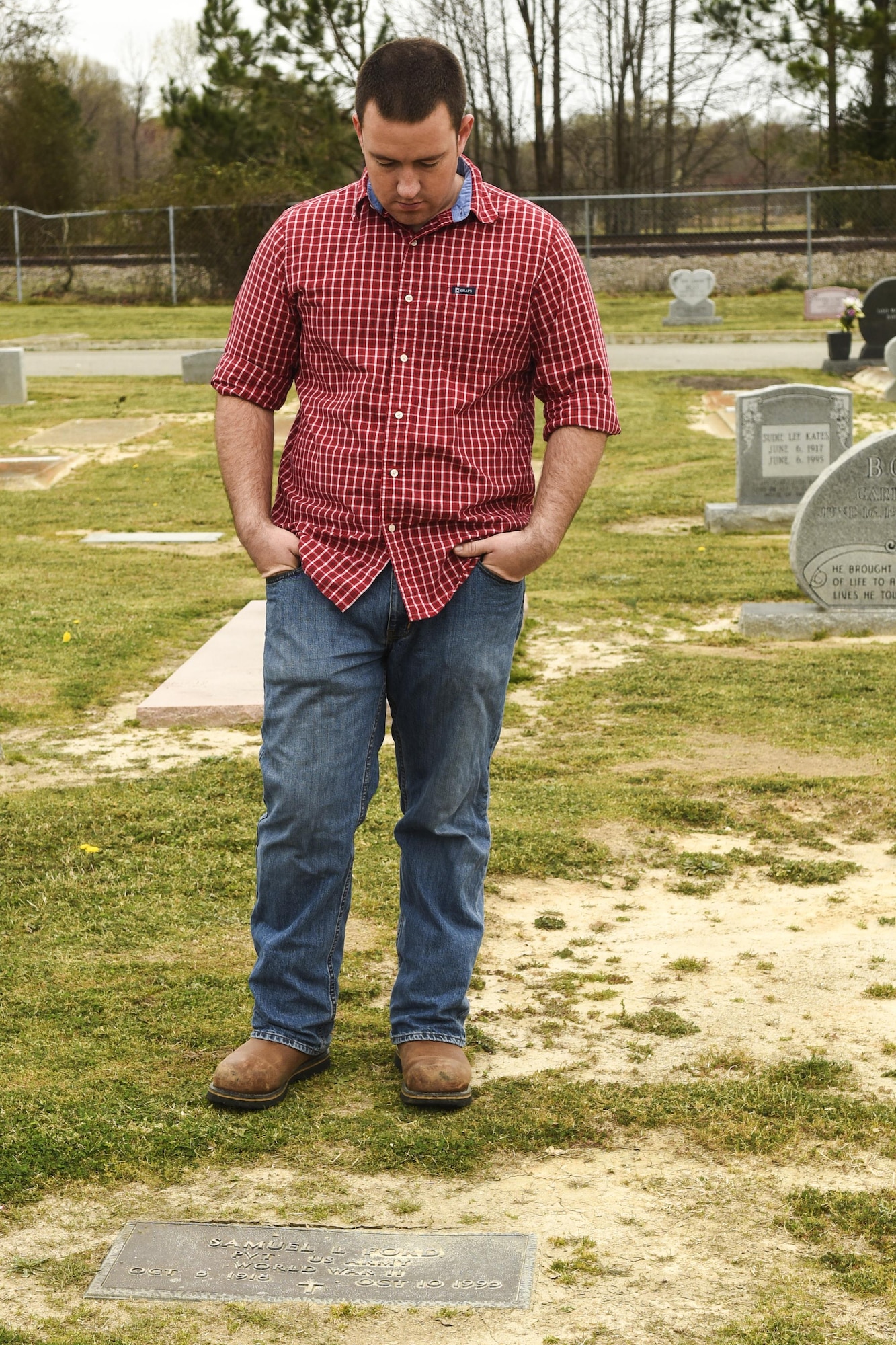 Senior Airman Josiah Seale, 4th Aircraft Maintenance Squadron weapons loadcrew chief, pauses at the gravestone of a veteran, March 12, 2016, in Goldsboro, North Carolina. Airmen from the Airman Leadership School class 16-C split into teams to map and document the location of veterans buried at Elmwood Cemetery, one of Goldsboro’s oldest gravesites. (U.S. Air Force photo/Airman Shawna L. Keyes)