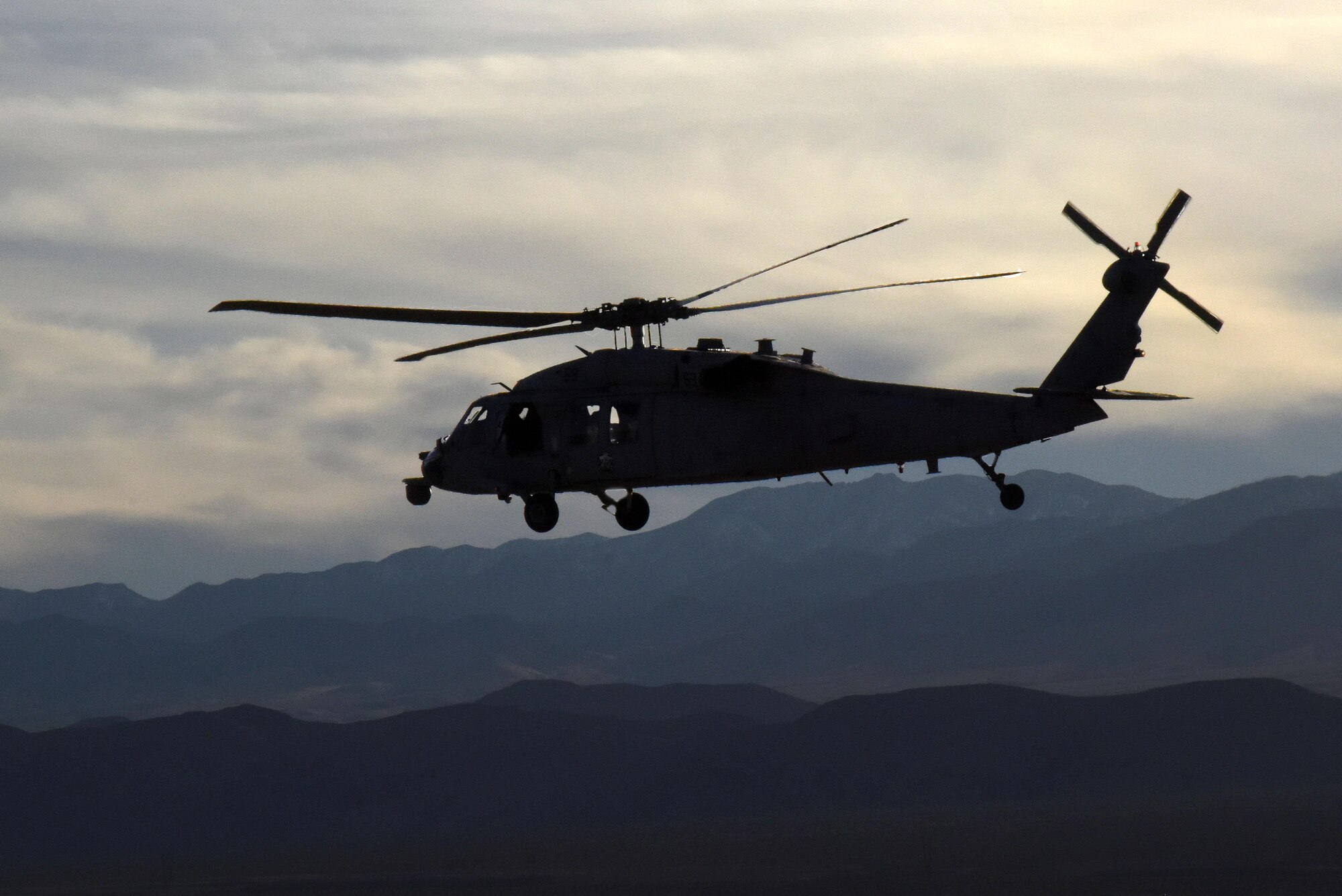 A U.S. Navy MH-60 Seahawk from Naval Air Station North Island, Calif., heads back to Nellis Air Force Base, Nevada following completion of a joint-service personnel rescue training mission March 2, 2016. The mission, part of Red Flag 16-2, involved the extraction of a downed U.S. Air Force F-16 pilot and used assets from several Department of Defense agencies in an effort to enhance joint-operations capabilities. (U.S. Air Force photo/Staff Sgt. Chuck Broadway)