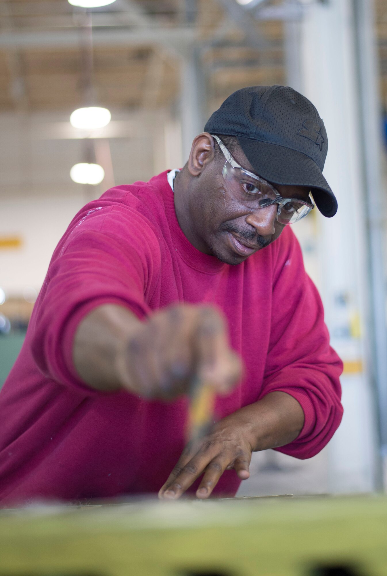 Master Sgt. Antoine Robinson, 512th Maintenance Squadron, repairs chaff strips on a C-5M Super Galaxy toe ramp on Dover Air Force Base, Del., March 18, 2016. Robinson earned an associate degree in Aviation Maintenance Technology through the Community College of the Air Force and graduates this spring. (U.S. Air Force photo/Capt. Bernie Kale) 