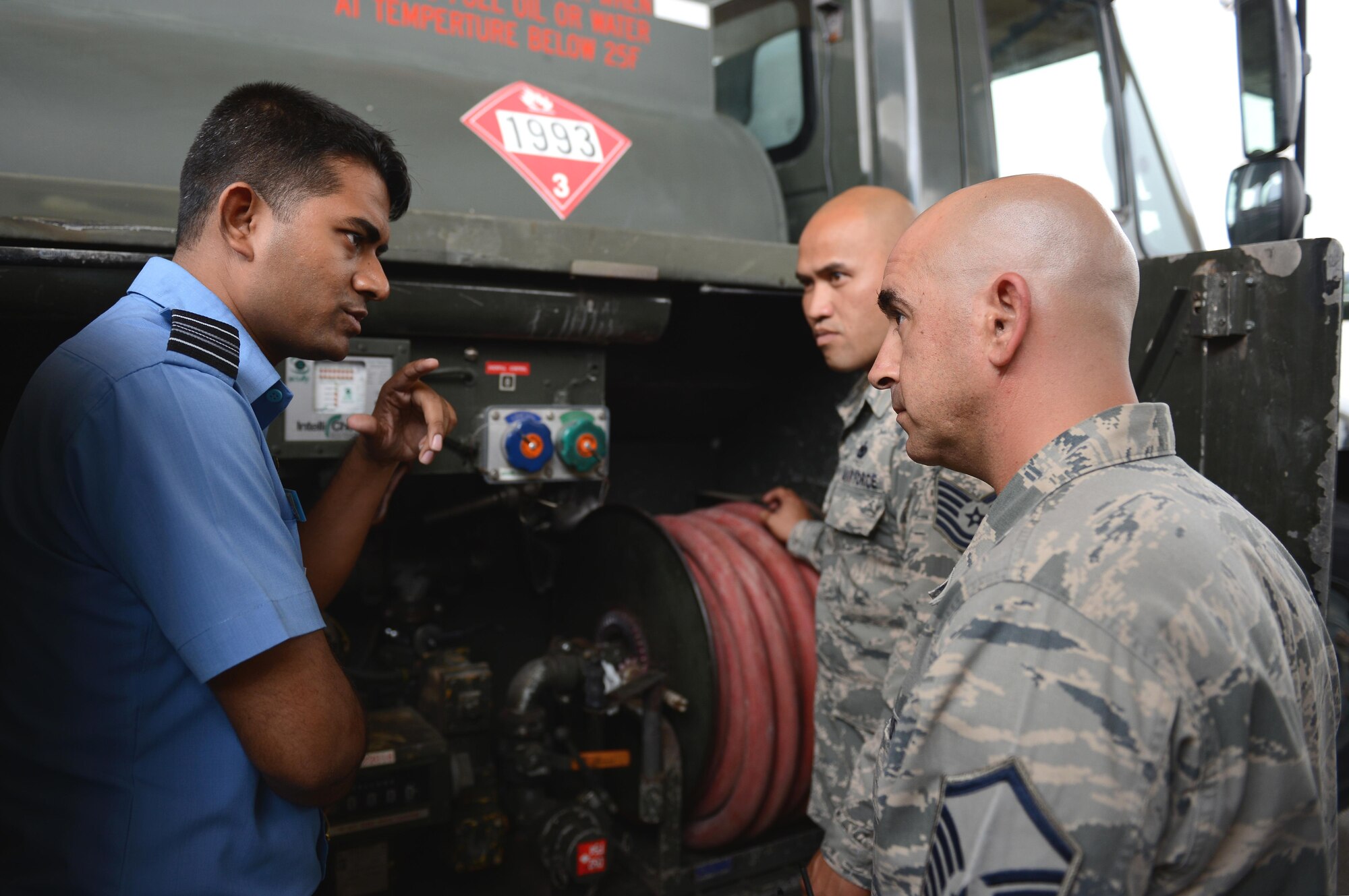 Squadron Leader Mohammad Ashraf, Bangladesh Air Force representative, left, discusses operational capabilities with fuels distribution experts during Pacific Agility 16-1, March 17, 2016, at Andersen Air Force Base, Guam. Pacific Agility is a Pacific Air Forces-led engagement focusing on a series of logistics subject-matter expert exchanges designed to increase partner capabilities, military relations and regional stability for the Indo-Asia-Pacific region. (U.S. Air Force photo by Airman 1st Class Arielle Vasquez/Released)