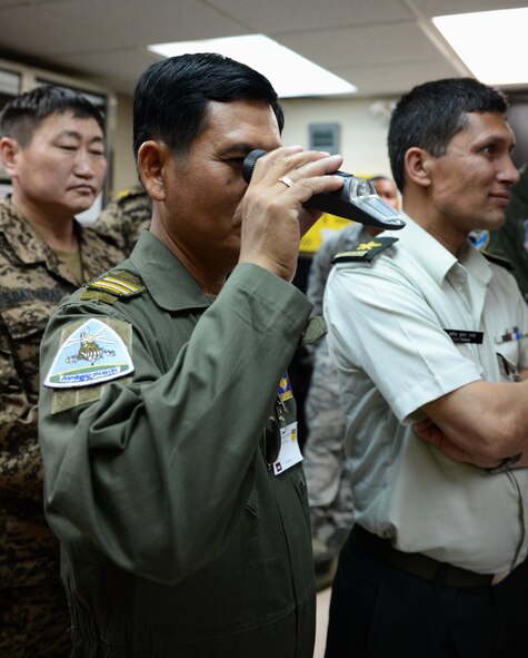 Lt. Col. Kong Rithy, Royal Cambodian Air Force weapons and aerodrome specialist, looks at a refractometer March 17, 2016, at Andersen Air Force Base, Guam. A refractometer is a tool used to determine percentages of fuel additives. Pacific Agility is a Pacific Air Forces-led engagement focusing on a series of logistics subject-matter expert exchanges designed to increase partner capabilities, military relations and regional stability for the Indo-Asia-Pacific region. (U.S. Air Force photo by Airman 1st Class Arielle Vasquez/Released)