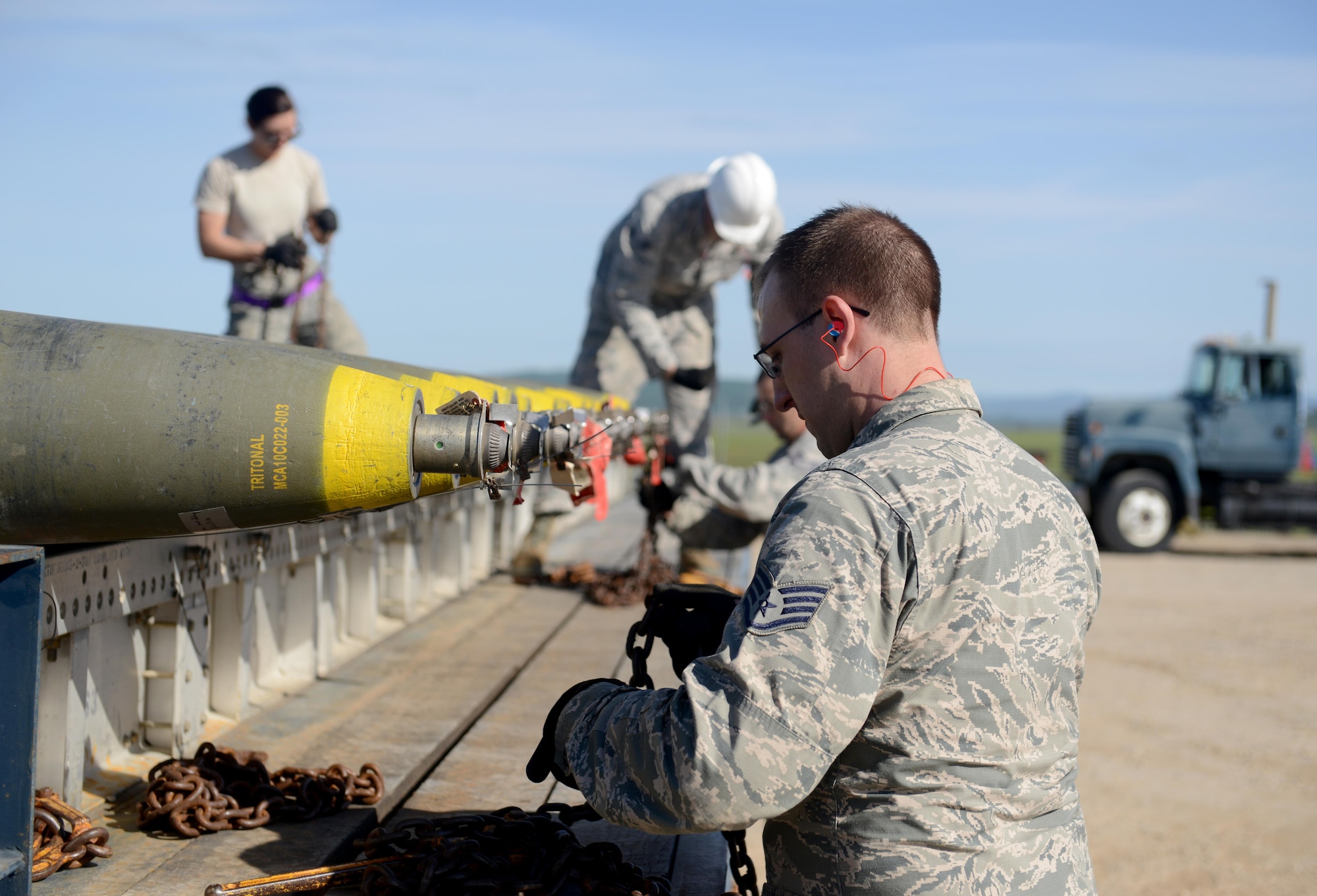 Airmen attending the Air Force Combat Ammunition Center (AFCOMAC) Combat Ammunition Planning and Production course, load ordnance onto a truck March 15, 2016, at Beale Air Force Base, California. AFCOMAC is celebrating its’ 30th Anniversary this year. (U.S. Air Force photo by Senior Airman Bobby Cummings)