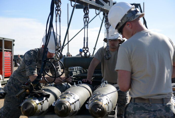 Airmen attending the Air Force Combat Ammunition Center (AFCOMAC) Combat Ammunition Planning and Production course assemble munitions March 15, 2016, at Beale Air Force Base, California. Thirty years ago, the course was developed to provide the Air Force munitions community advanced combat training in mass munitions planning and production techniques. (U.S. Air Force photo by Senior Airman Bobby Cummings) 