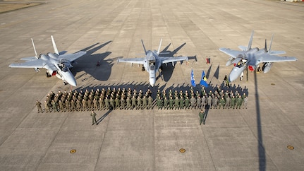 Members of Marine Fighter Attack Squadron (VMFA) 314 and Japan Air Self-Defense pose for a photo in front of an F/A-18AA++ and two F-15s at Komatsu Air Base, Japan, during the Komatsu Aviation Training Relocation exercise March 17, 2016. VMFA-314, home based out of Marine Corps Air Station Miramar, San Diego, temporarily deployed to MCAS Iwakuni for a six month rotation with the unit deployment program, is forward deployed to Komatsu, Japan for the ATR.  Komatsu ATR is a dissimilar air combat training exercise allowing pilots with diverse aircraft to simulate aerial warfare and execute basic fighter maneuvers, aircraft tactical intercepts and offensive-defensive counter air missions in preparation for real wartime situations. 