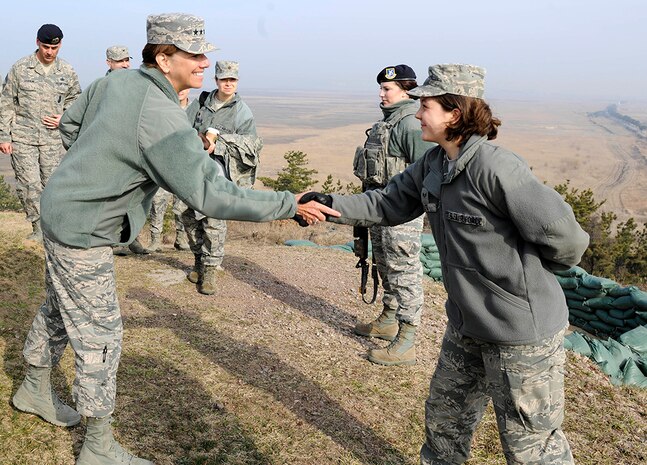 Gen. Lori J. Robinson, Pacific Air Forces commander, shakes hands with Senior Airman Kimberlee Kutt, 8th Force Support Squadron fitness center journeyman during her visit to Kunsan Air Base, Republic of Korea, March 17, 2016. Robinson had the opportunity to see firsthand how Kunsan Airmen contribute to deterring aggression on the Korean Peninsula during her visit to Kunsan.