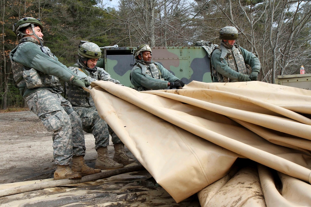 Soldiers drain a potable water holding bag in preparation for storage at the Brindle Lake training area on Joint Base McGuire-Dix-Lakehurst, N.J., March 6, 2016. The soldiers are assigned to the 431st Quartermaster Company. Army photo by Spc. Michael McDevitt