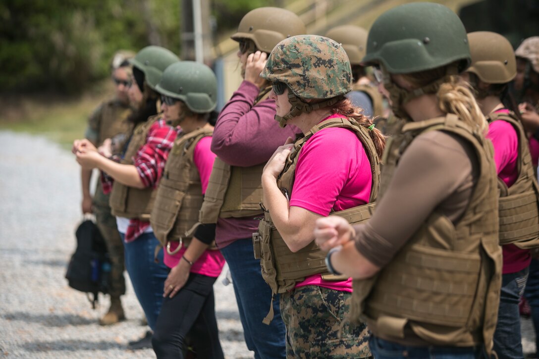 Marine spouses and family members receive safety briefs before conducting pistol and rifle ranges during a Jane Wayne event on Camp Schwab, Okinawa, Japan, March 18, 2016. These events bring families closer together, increase bonds and give loved ones a closer look at what their Marines do every day. The event was hosted by Combat Assault battalion, 3rd Marine Division, III Marine Expeditionary Force. (U.S. Marine Corps photo by Cpl. William Hester/ Released)