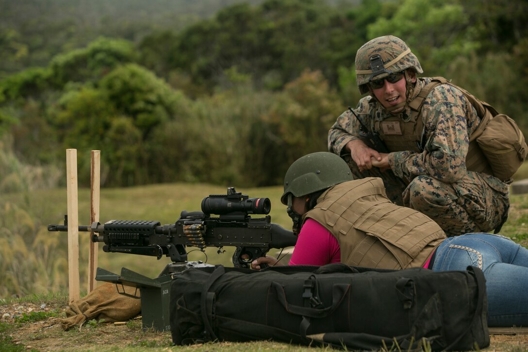 Latoya M. Williams fires an M240B medium machine gun during a Jane Wayne event on Camp Schwab, Okinawa, Japan March 18, 2016. Jane Wayne is an event that allows Marines from Combat Assault Battalion to bring their spouses or family members to interact in military based events. The events give them a better idea of what their service member does every day. At this event spouses and family members were able to shoot rifles, pistols, machine guns and ride in amphibious assault vehicles. Williams is from Crystal Springs, Mississippi, and married to 1st Sgt. Ceasare Williams, CAB, 3rd Marine Division, III Marine Expeditionary Force. (U.S. Marine Corps photo by Cpl. William Hester/released)