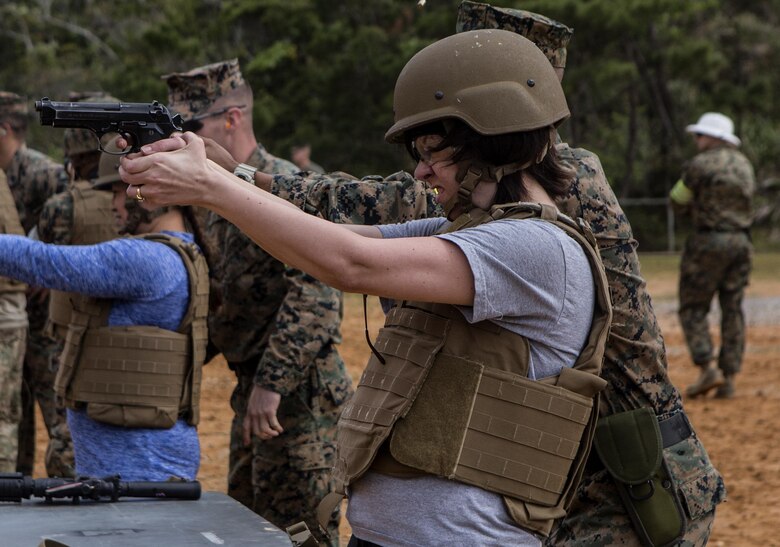 Gina N. Hoss, wife of Chief Warrant Officer 3 Milton W. Hoss, fires the M9 service pistol during Jayne Wayne Day on Camp Schwab, March 18, 2016. During the day Gina learned to fire the M4-A1 carbine rifle and a M240B medium machine gun. Jayne Wayne Day is an event to help show Marine families what a day is like for a Marine. The event was hosted by Combat Assault Battalion, 3rd Marine Division, III Marine Expeditionary Force. (U.S. Marine Corps photo by Lance Cpl. Jessica N. Etheridge/Released)