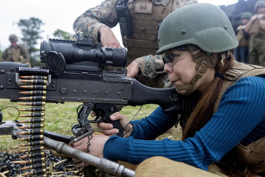 Ayumi Marsh, wife of SSgt. Anthony K. Marsh, fires the M240B medium machine gun during Jayne Wayne Day on Camp Schwab, March 18, 2016. Throughout the day Ayumi learned to fire the M9 service pistol and M4-A1 carbine rifle. Jayne Wayne Day is an event Marines families attend to experience a day in the life of their Marine. The event was hosted by Combat Assault Battalion, 3rd Marine Division, III Marine Expeditionary Force. (U.S. Marine Corps photo by Lance Cpl. Jessica N. Etheridge/Released)