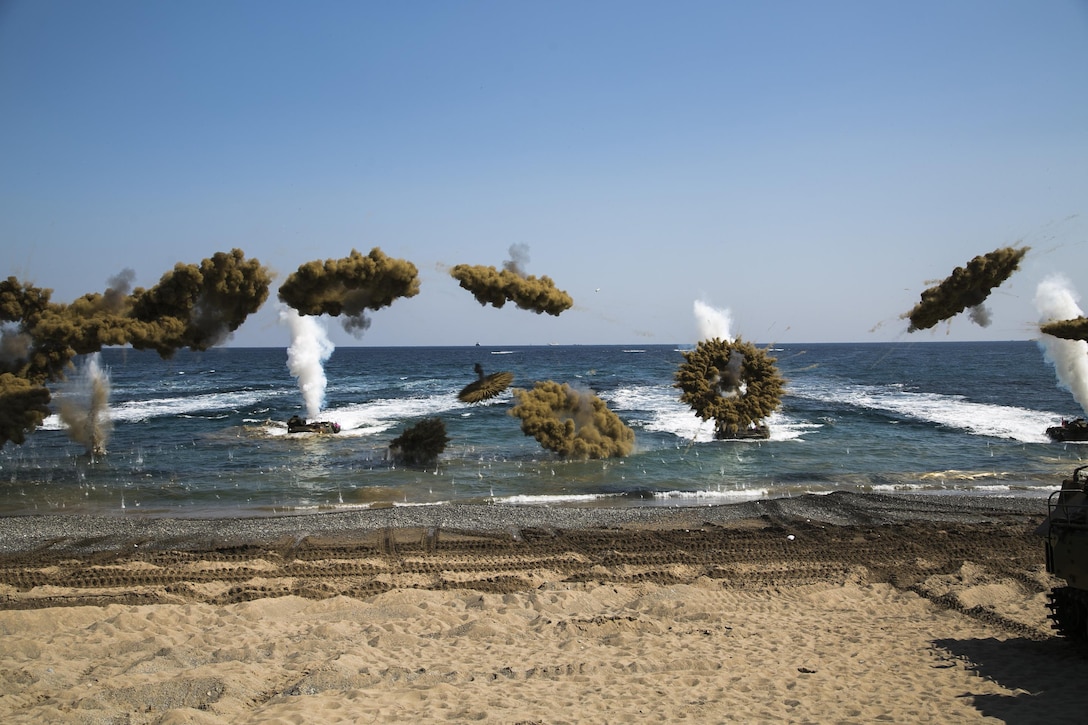 Amphibious assault vehicles fire smoke bombs as U.S. Marines and troops from South Korea, New Zealand and Australian conduct amphibious assault training at Doksukri Beach, South Korea, March 12, 2016, during Exercise Ssang Yong 16. Marine Corps photo by Sgt. Briauna Birl