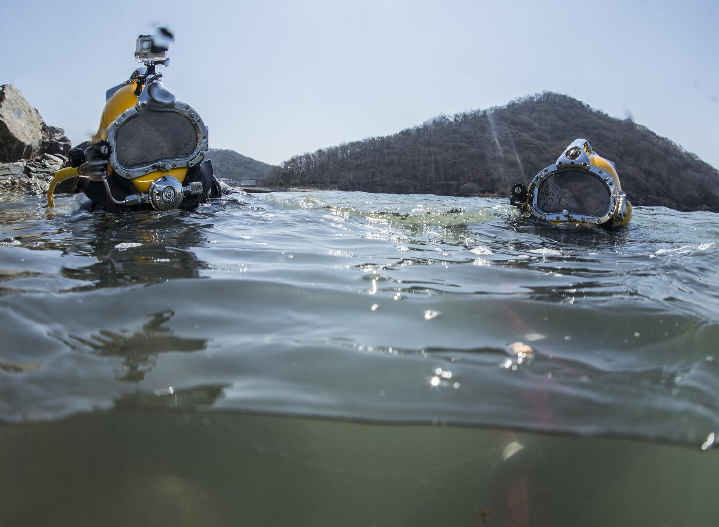 U.S. Navy Lt. Christopher Ferguson, right, and South Korean Chief Petty Officer Dong Soon-jung exit the water after working on a simulated expeditionary wharf during Exercise Foal Eagle 2016 at Chinhae, South Korea, March 10, 2016. Navy photo by Petty Officer 1st Class Charles E. White