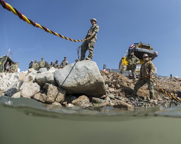 U.S. Navy Petty Officer 2nd Class Jesus Saucedo Gomez, right, and Petty Officer 3rd Class Ryan Marsi monitor U.S. and South Korean divers as they work on a simulated expeditionary wharf during Exercise Foal Eagle 2016 at Chinhae, South Korea, March 10, 2016. Gomez is a builder and Marsi is an information systems technician assigned to Underwater Construction Team 2. Navy photo by Petty Officer 1st Class Charles E. White