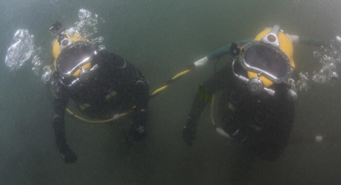U.S. Navy Lt. Christopher Ferguson, right, and South Korean Chief Petty Officer Dong Soon-jung move toward their project site during Exercise Foal Eagle 2016 at Chinhae, South Korea, March 10, 2016. Navy photo by Petty Officer 1st Class Charles E. White