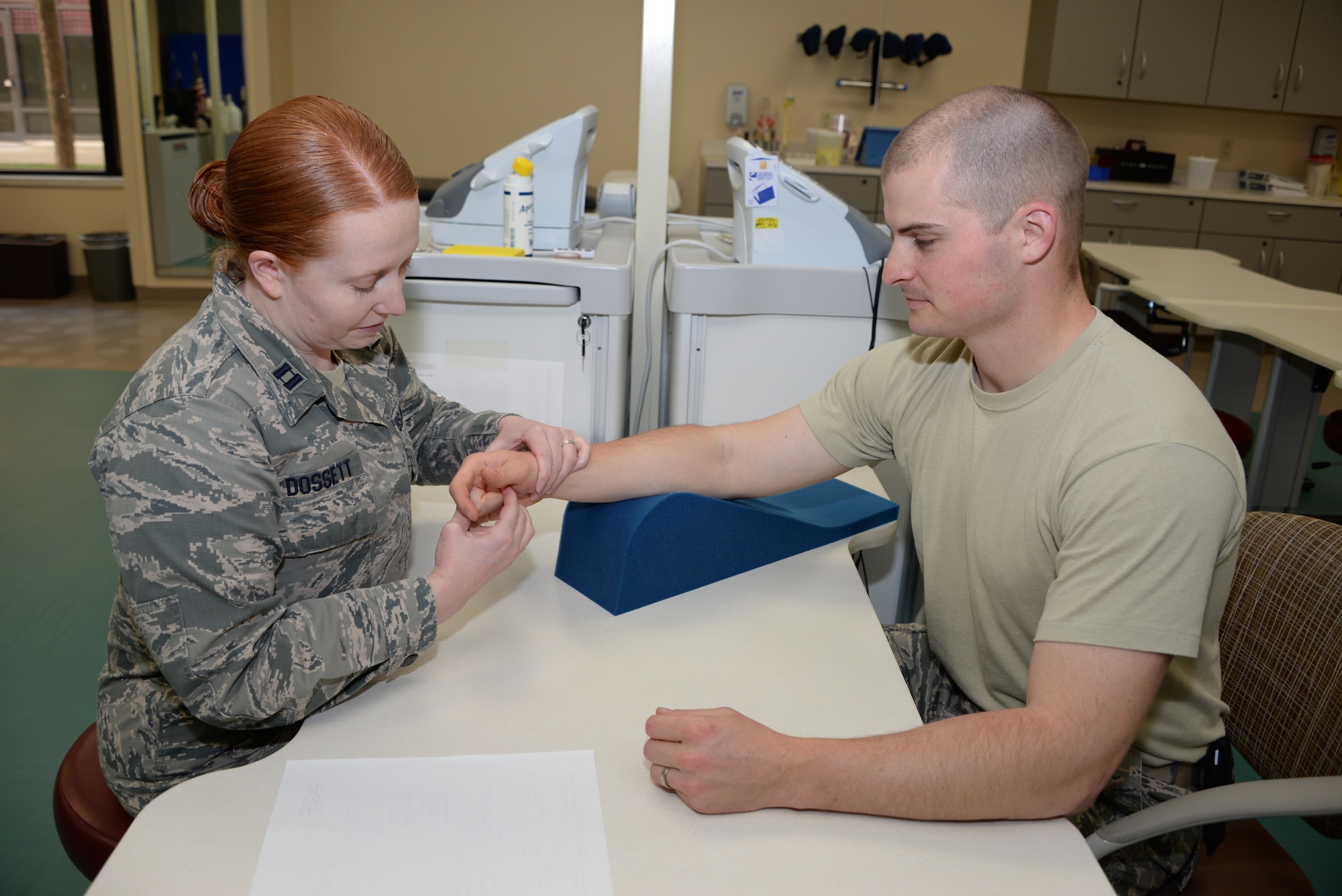Capt. Laura Dossett, 60th MDOS occupational therapist, demonstrates range of motion March 16 at David Grant USAF Medical Center. Stiff fingers are common after an injury and occupational therapists provide treatment and care of injuries. (U.S. Air Force photo by Senior Airman Amber Carter)