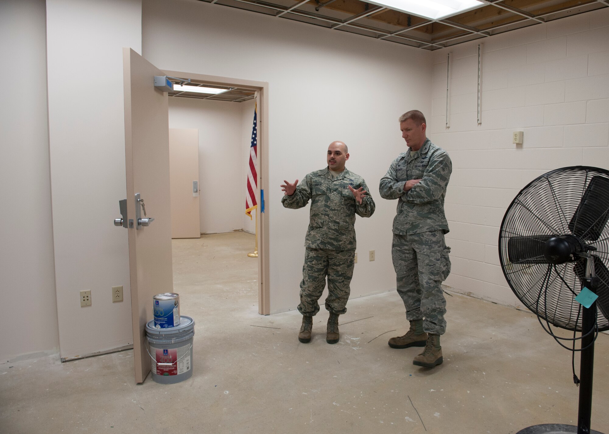 Tech. Sgt. Raymond Silva, 436th Logistics Readiness Squadron, takes Col. Michael Grismer, 436th Airlift Wing commander, on a tour of the construction inside the installation deployment readiness center March 16th, 2016, on Dover Air Force Base, Del. The construction will provide the IDRC with additional office space and a classroom. (U.S. Air Force photo/Senior Airman Zachary Cacicia)