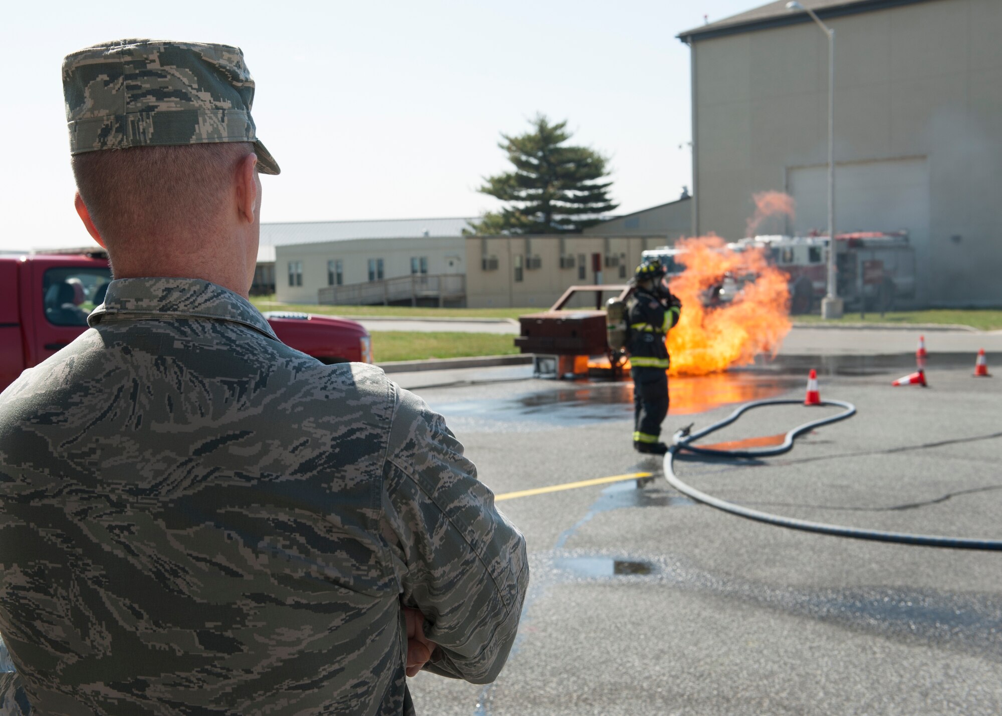 Col. Michael Grismer, 436th Airlift Wing commander, watches a fire fighting demonstration March 16th, 2016, on Dover Air Force Base, Del. Grismer took a tour of the fire department to get a better understanding of its capabilities and to meet with the Airmen. (U.S. Air Force photo/Senior Airman Zachary Cacicia)