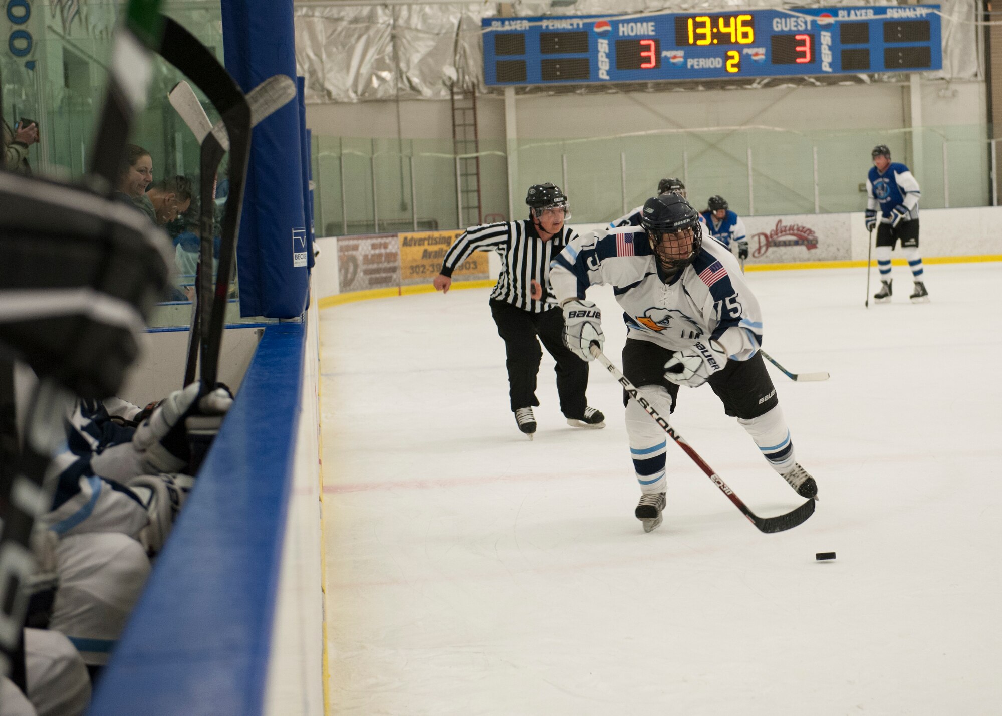 Mike Roth, Dover Eagles center, carries the puck through the neutral zone during a charity hockey game March 13, 2016, at the Centre Ice Rink in Harrington, Del. The Eagles took on the Fraternal Order of Police Lodge 15 hockey team. (U.S. Air Force photo/Senior Airman Zachary Cacicia)