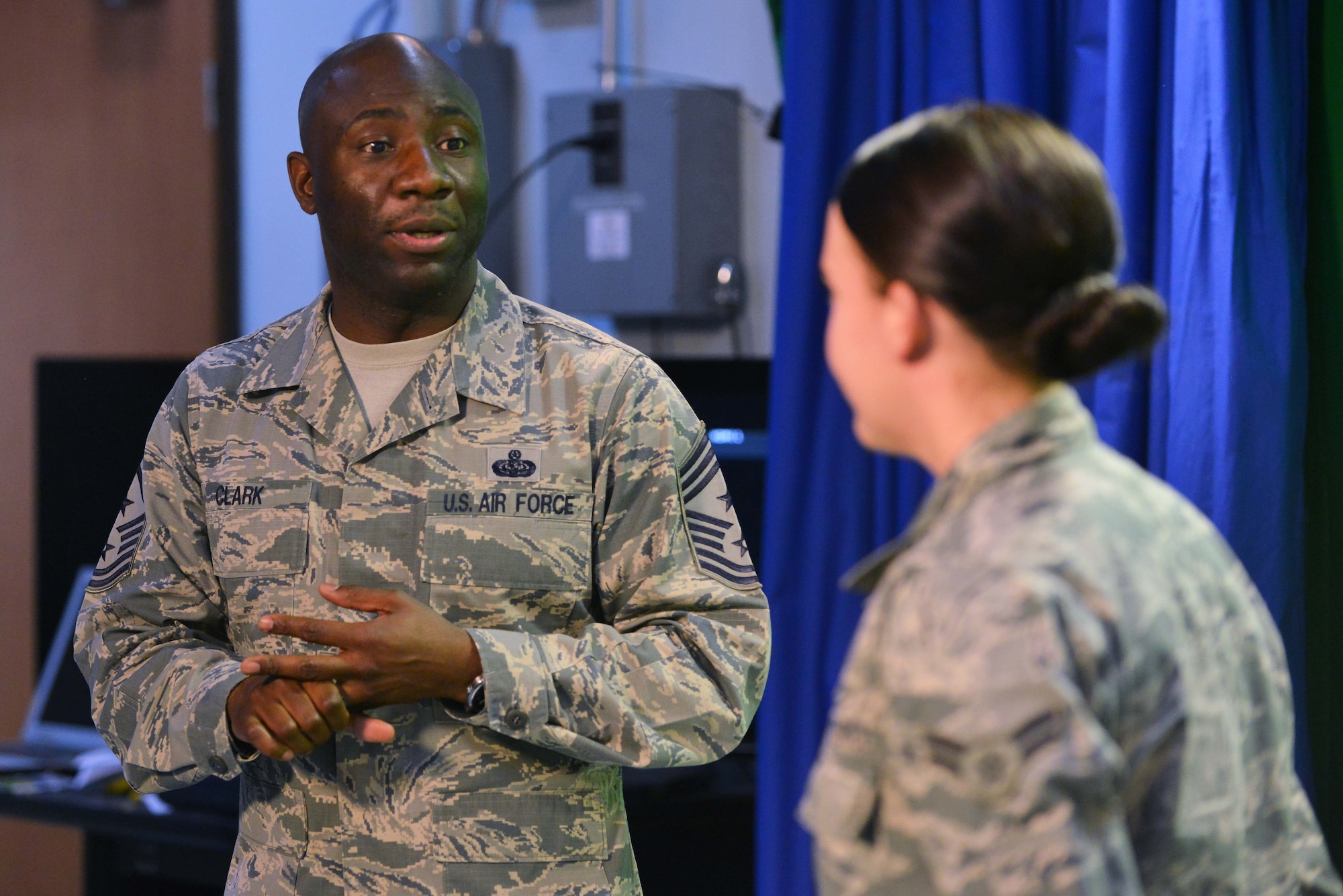 U.S. Air Force Chief Master Sgt. Vegas Clark, 39th Air Base Wing command chief, commends U.S. Air Force Airman 1st Class Katie Moeller, American Forces Network Incirlik broadcast producer, for her work in Titan University, March 11, 2016, at Incirlik Air Base, Turkey. Moeller has completed classes such as Little Brown Book…Little Blue Book, Customs and Courtesies, and Social Media and Email Protocol. (U.S. Air Force photo by Senior Airman John Nieves Camacho/Released)