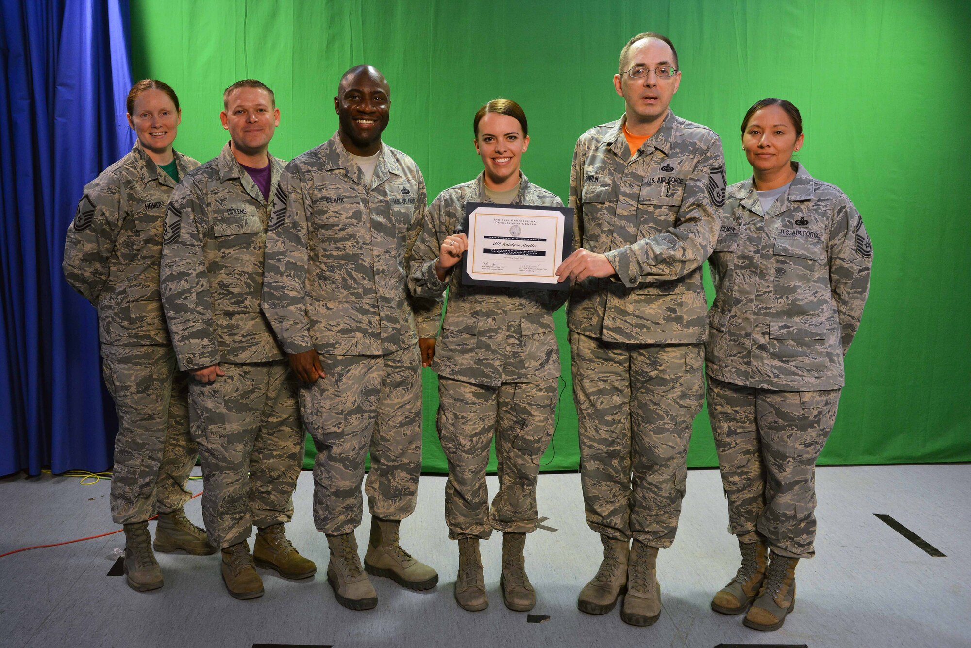 The Incirlik Air Base Top 3 presents U.S. Air Force Airman 1st Class Katie Moeller (middle), American Forces Network Incirlik broadcast producer, with a Titan University, “wingman level” award, March 11, 2016, at Incirlik Air Base, Turkey. Currently, Moeller has completed 11 classes spanning 11 hours total toward her Titan University education. (U.S. Air Force photo by Senior Airman John Nieves Camacho/Released)