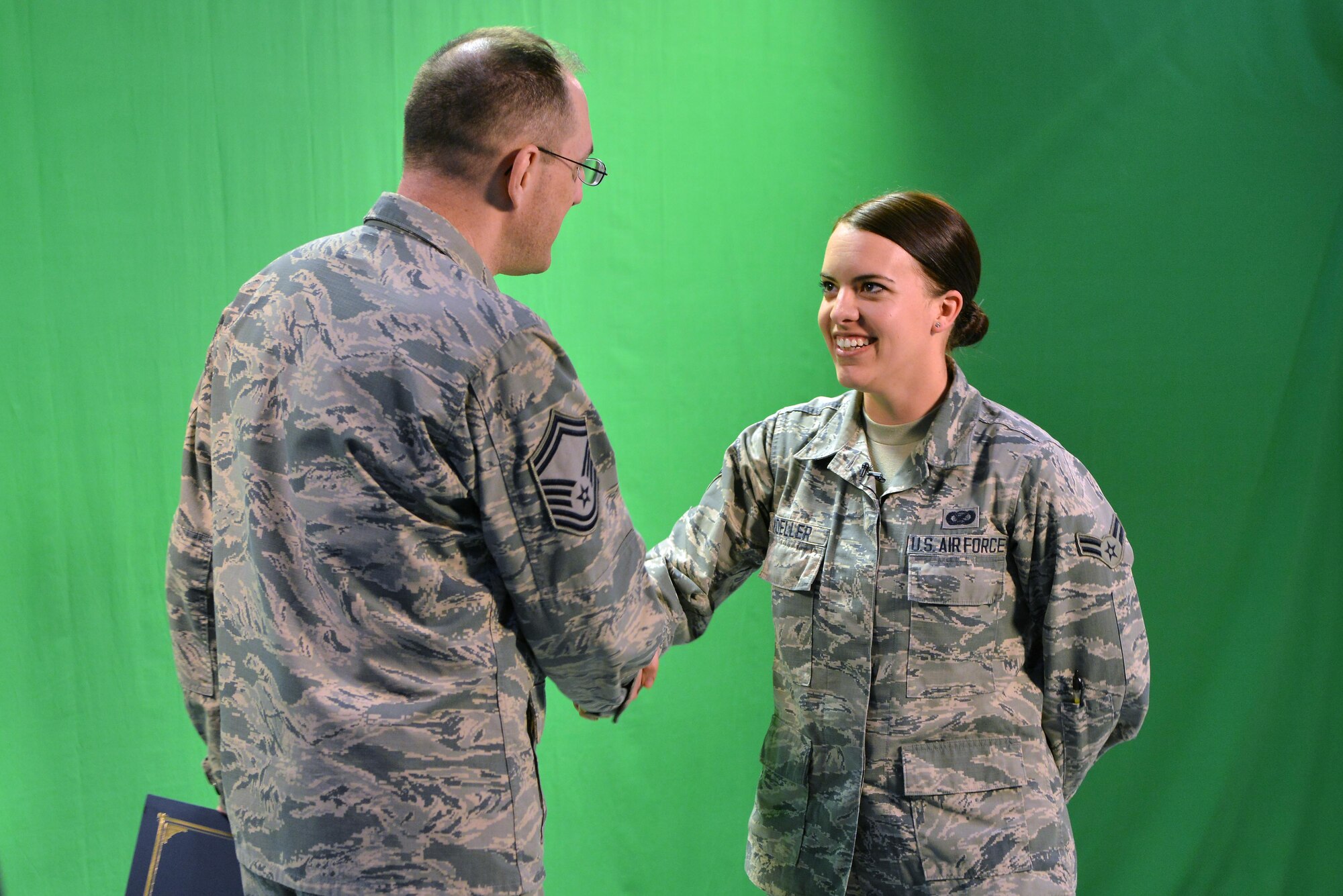 U.S. Air Force Senior Master Sgt. Kevin Pawlik, 39th Communications Squadron plans and programs flight superintendent, congratulates U.S. Air Force Airman 1st Class Katie Moeller, American Forces Network Incirlik broadcast producer, March 11, 2016, at Incirlik Air Base, Turkey. Moeller was recognized by the Incirlik Top 3 and presented with a Titan University, “wingman level” award, for completing five classes within the program. (U.S. Air Force photo by Senior Airman John Nieves Camacho/Released)