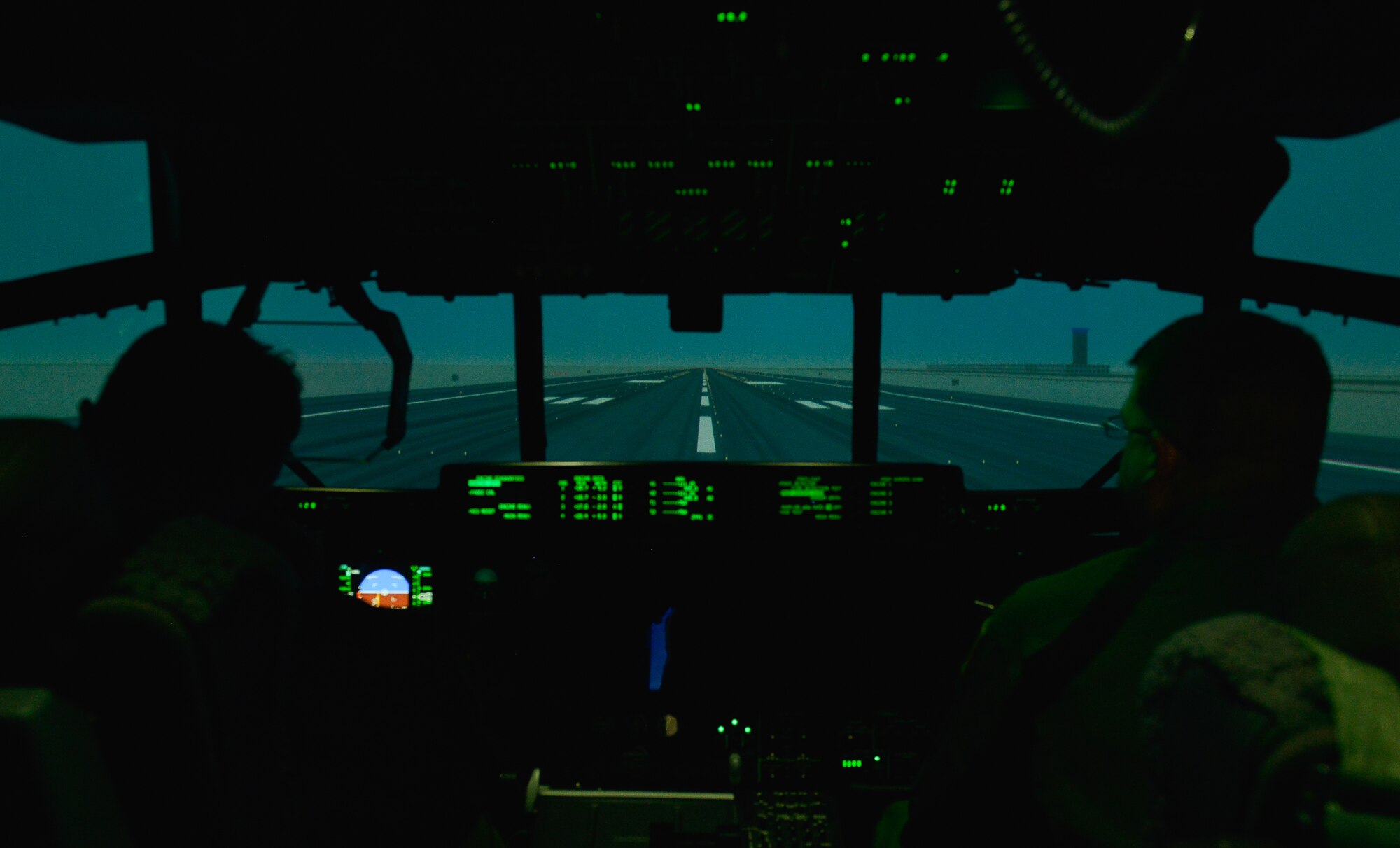 Lt. Col. Travis Shoemaker, Air Mobility Command test and evaluation pilot, and Master Sgt. Brian Harris, AMC test and evaluation loadmaster, work on the C-130J Super Hercules simulator March 16, 2016, at Ramstein Air Base, Germany. The simulator’s goal is to help both new and experienced pilots gain confidence in maintaining control of a C-130J through various training circumstances. (U.S. Air force photo/Airman 1st Class Lane T. Plummer)